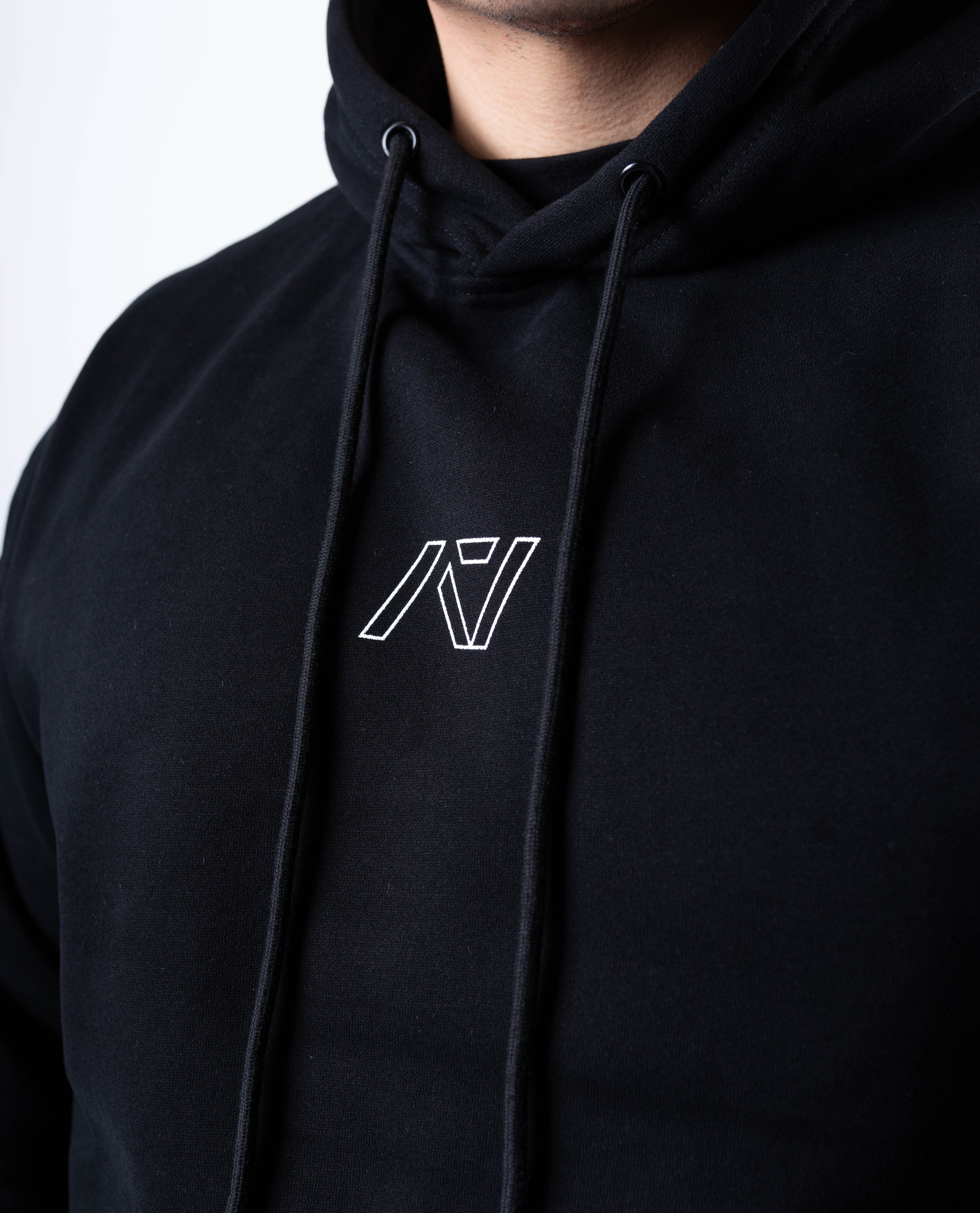 Close-up of the white A7 logo on the chest of the Built By Hoodie – Black, printed on soft fleece fabric for a clean, minimalist look.