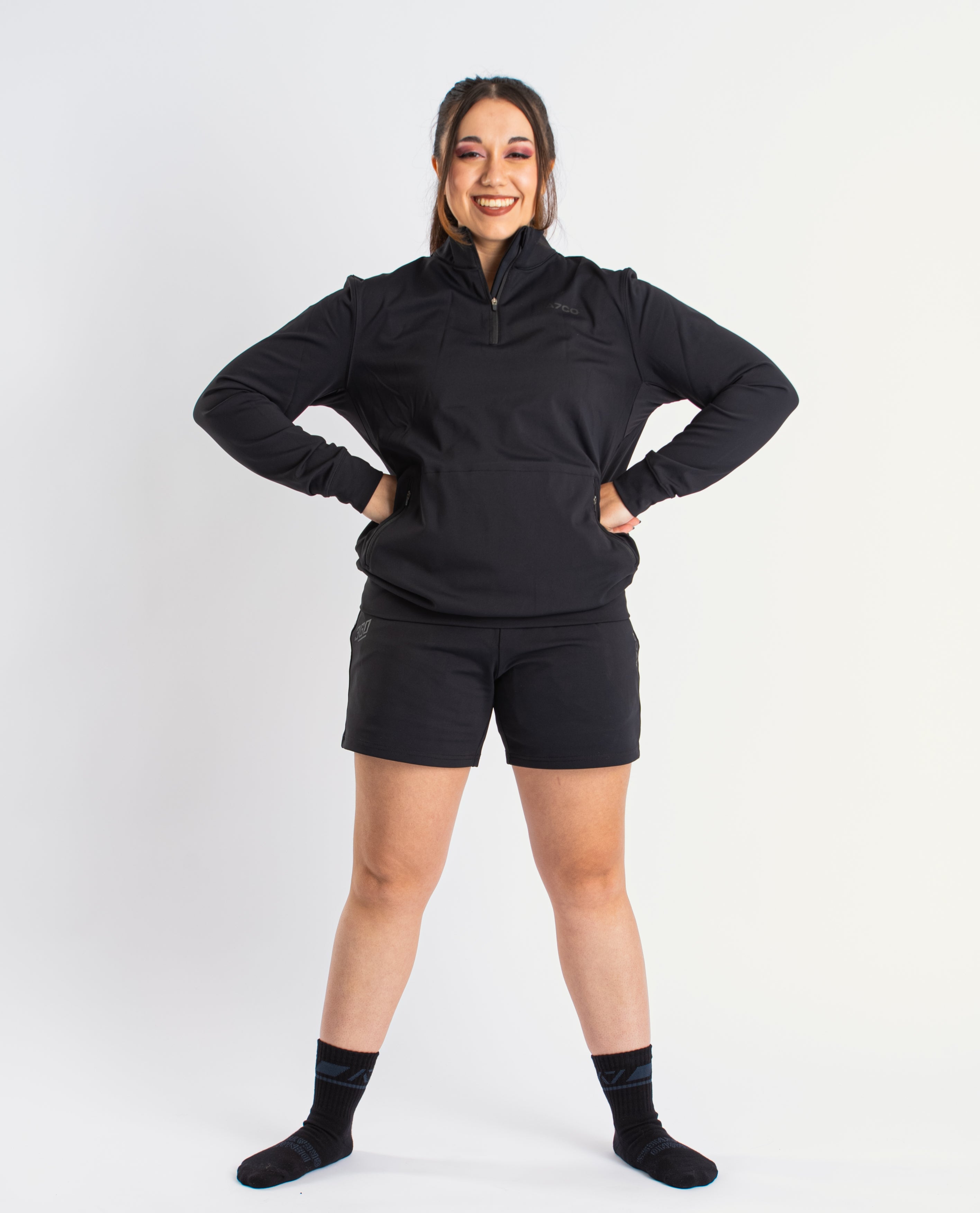 Athlete wearing the A7 Cobra Quarter Zip Jacket in Stealth, demonstrating fit and style in a gym setting.