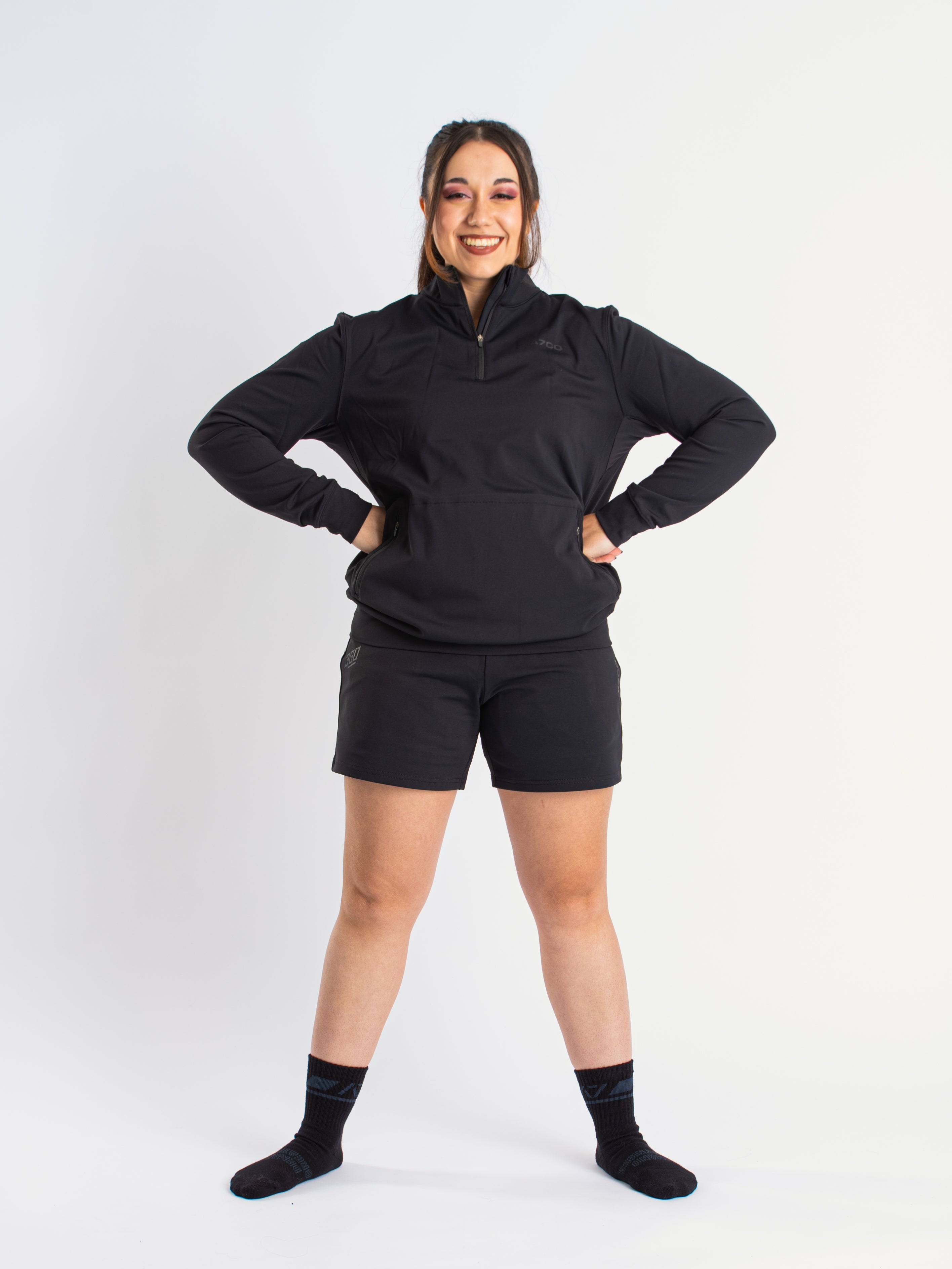 Athlete wearing the A7 Cobra Quarter Zip Jacket in Stealth, demonstrating fit and style in a gym setting.