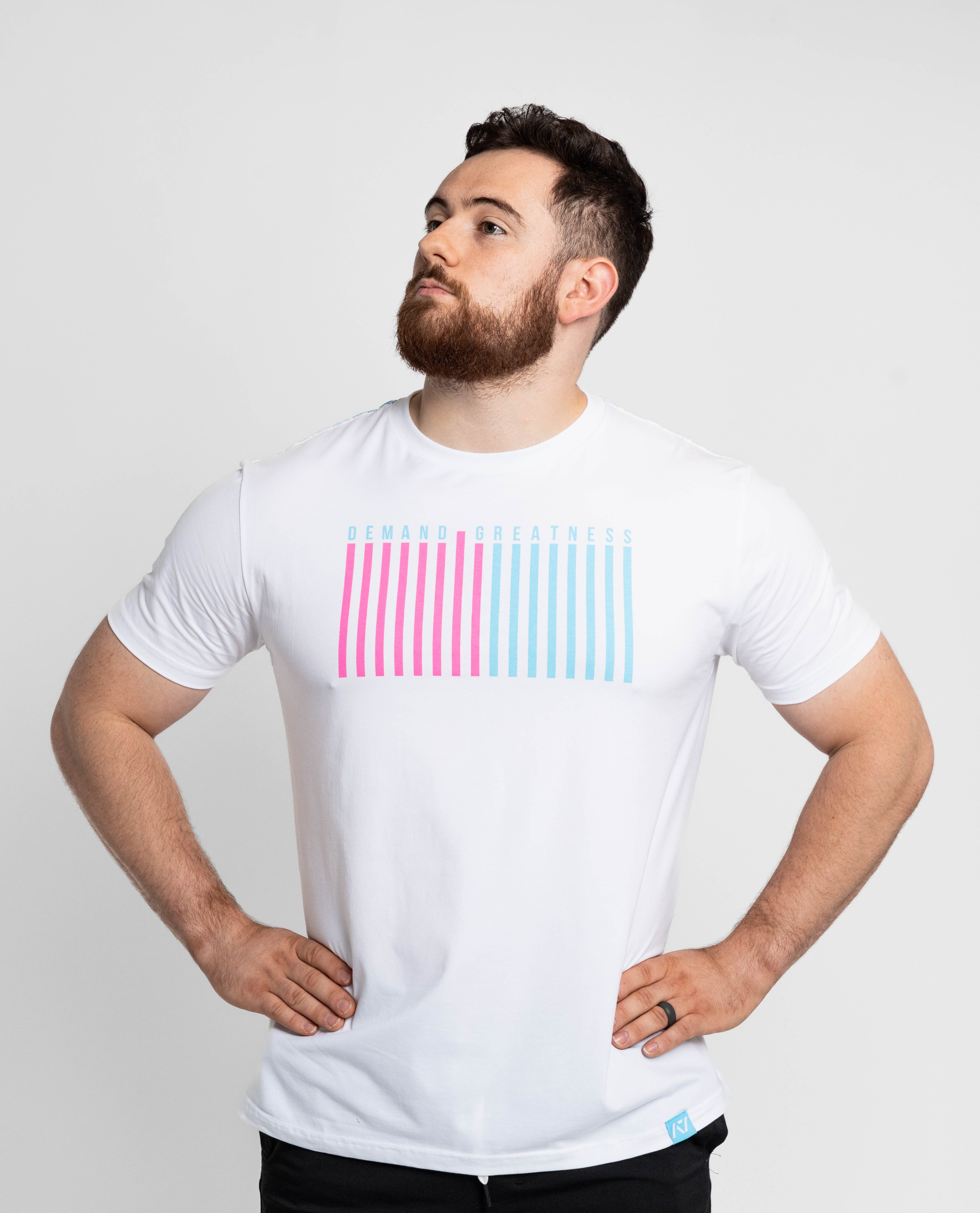 Man wearing a white t-shirt with pink and blue striped design on a light gray background