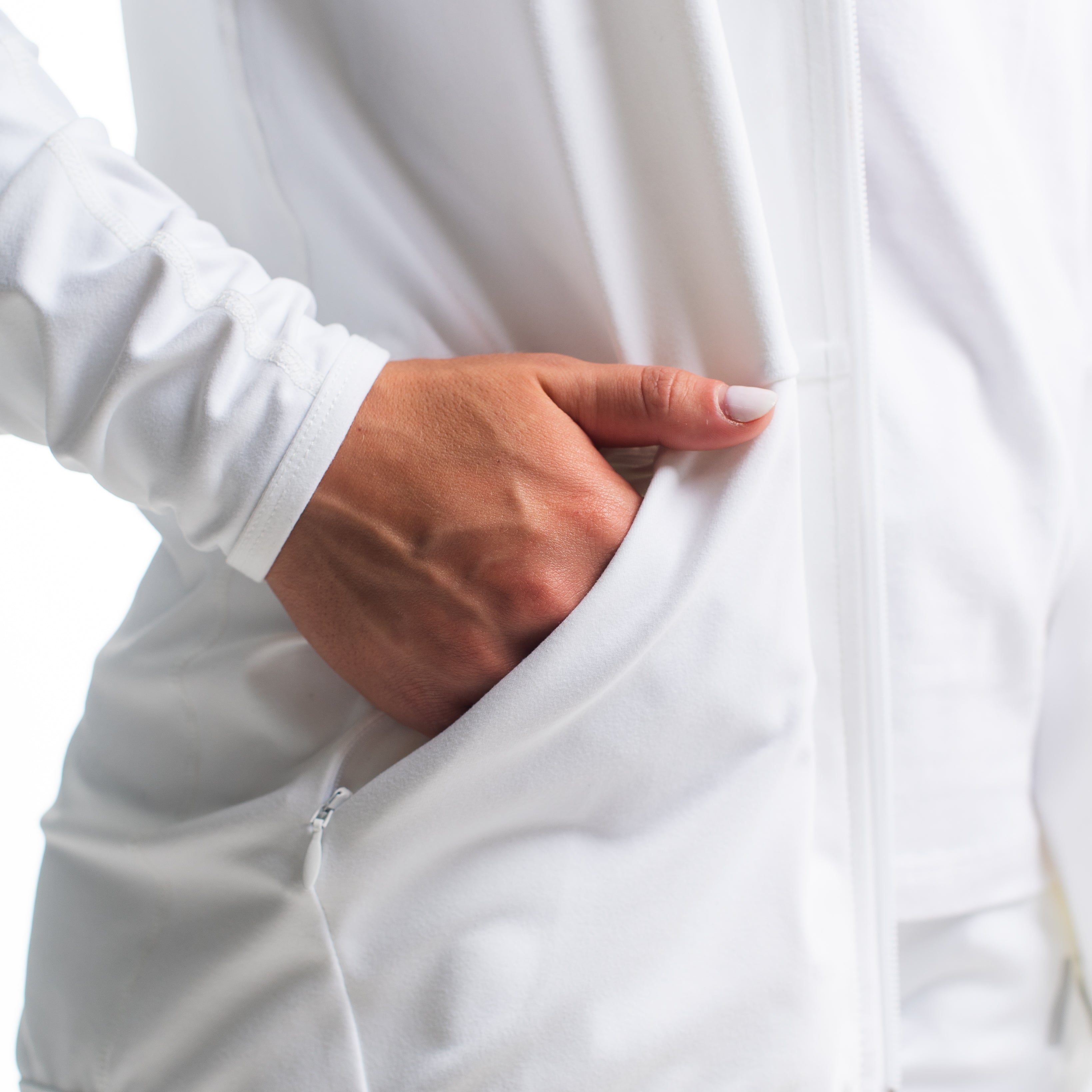 Close-up of the secure side zip pocket on the Defy Jacket – Polar, accented with stretch knit.