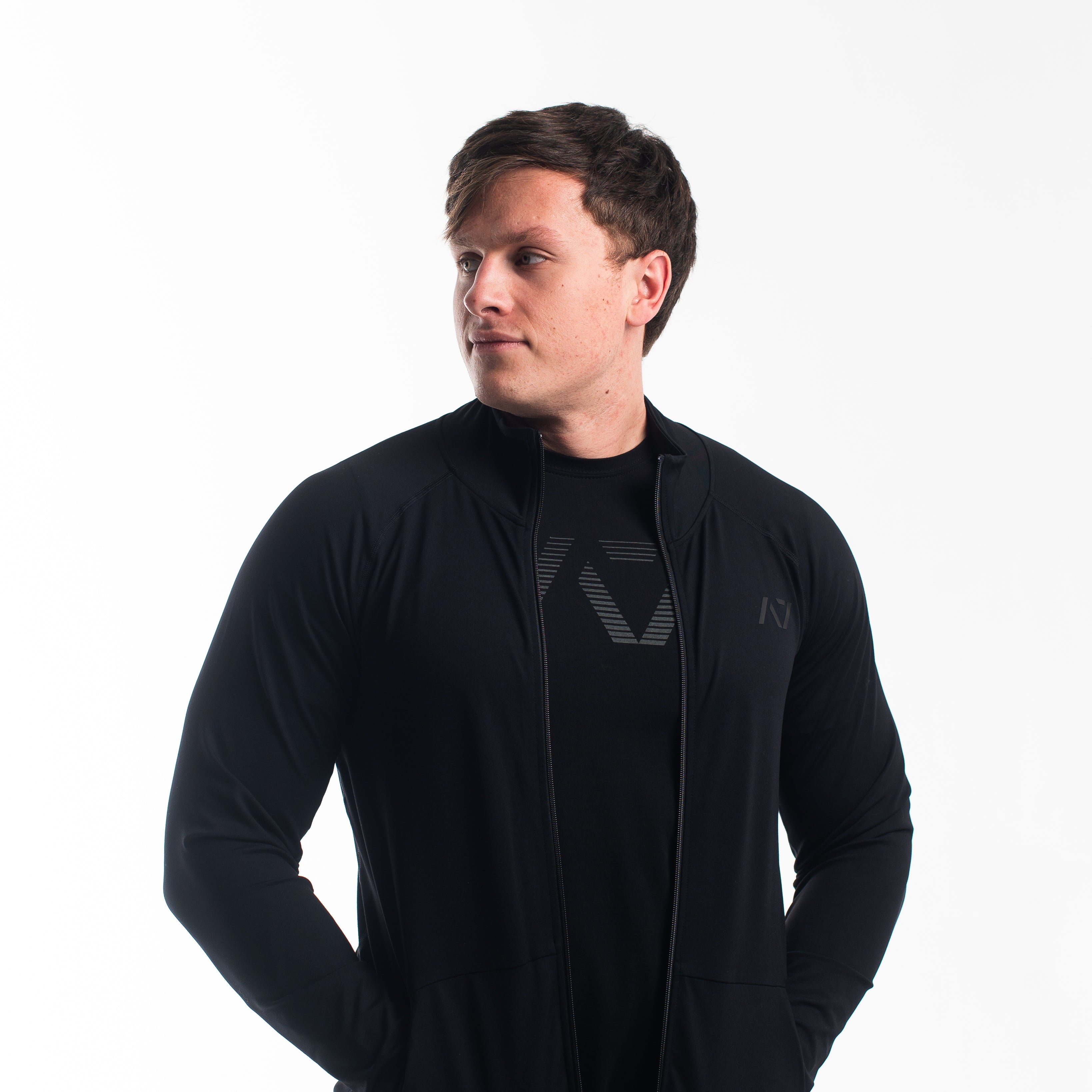 Front view of the A7 Defy Jacket – Stealth, showing clean unisex fit and front zipper design.