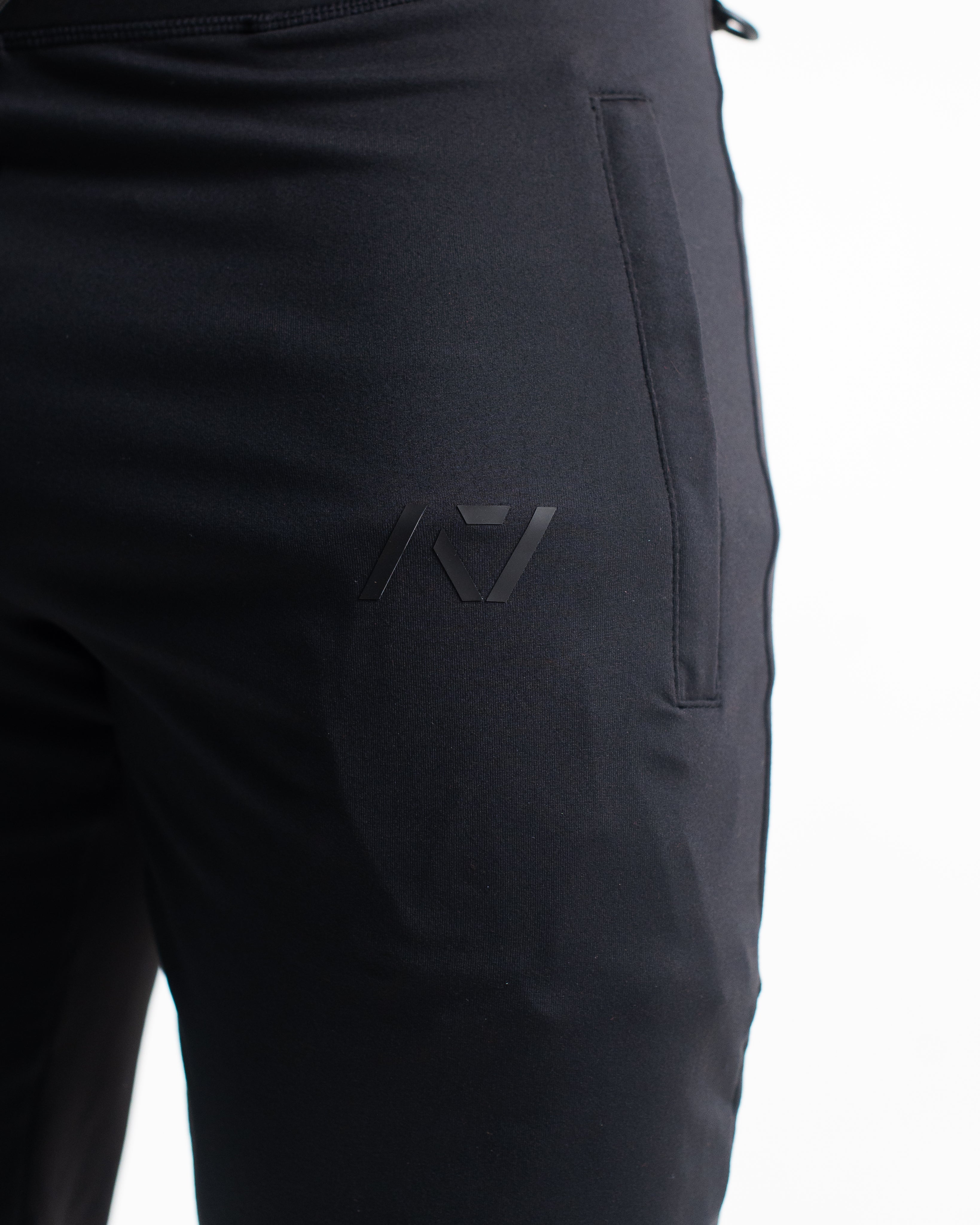 Close-up of silicone A7 logo printed on thigh and “Demand Greatness” quad text, for subtle branding.