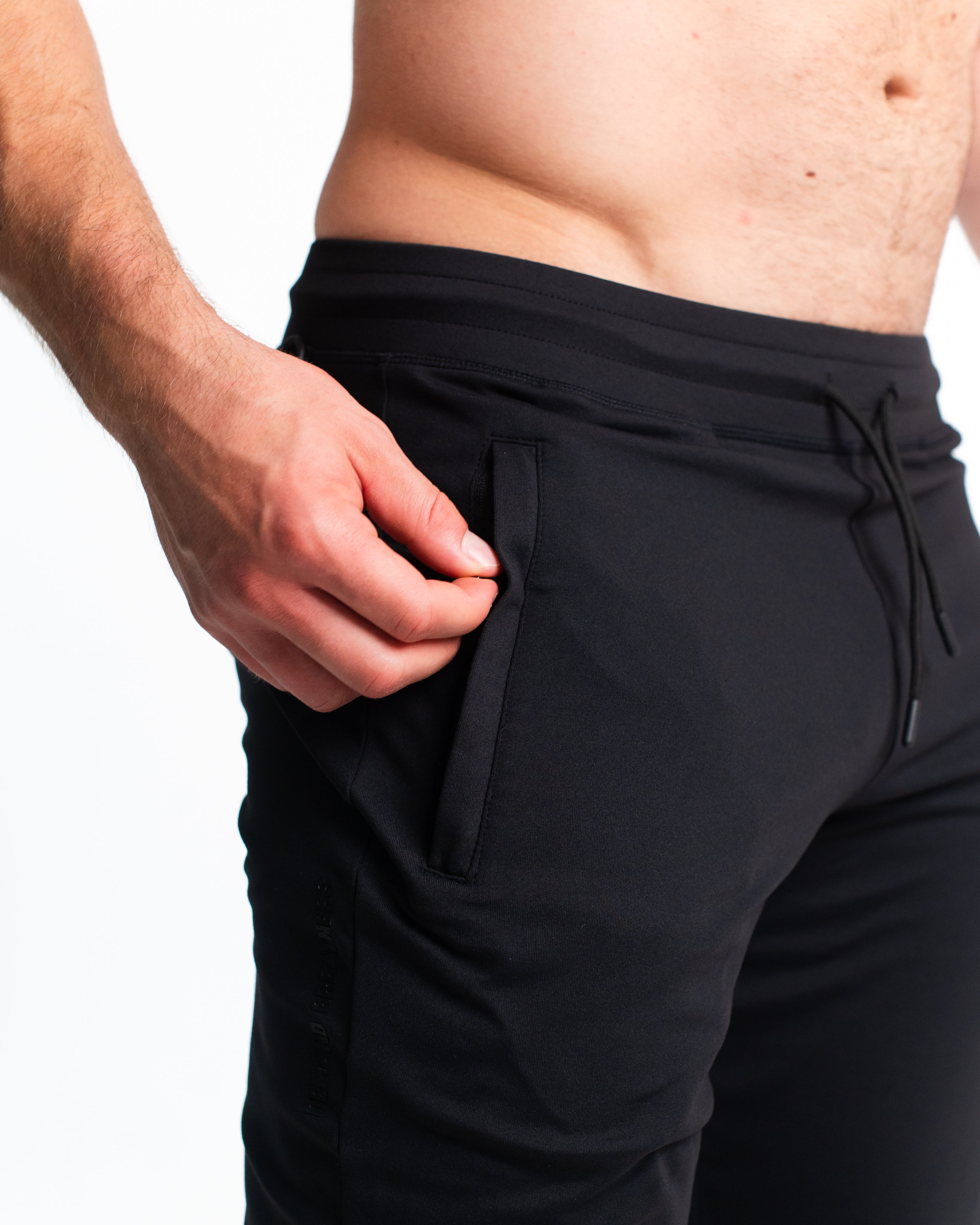 Close-up of zippered front pocket and fabric-integrated pull on Stealth Defy Joggers.