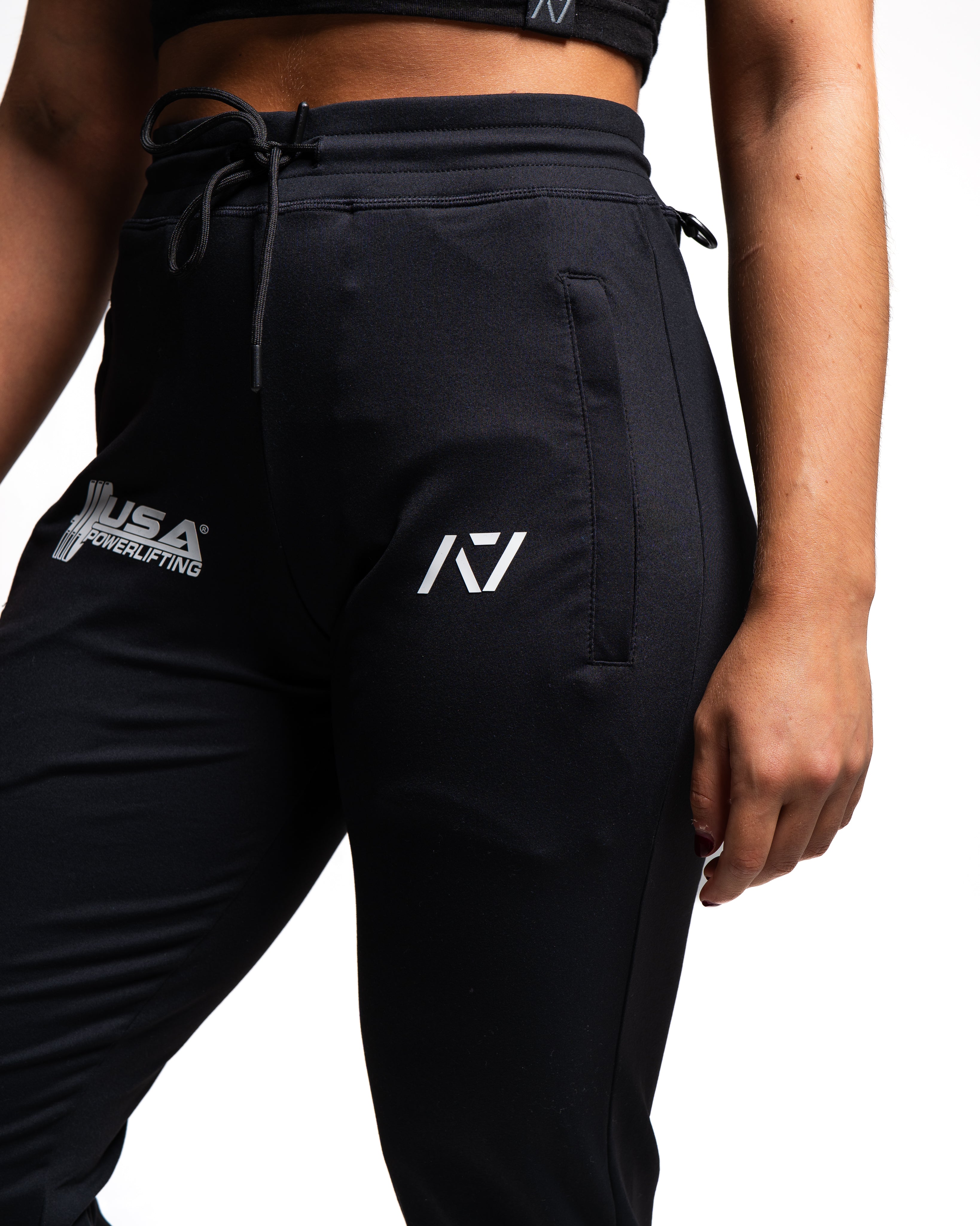 Close-up of the USAPL and A7 silicone logos printed on the front thigh of the joggers.