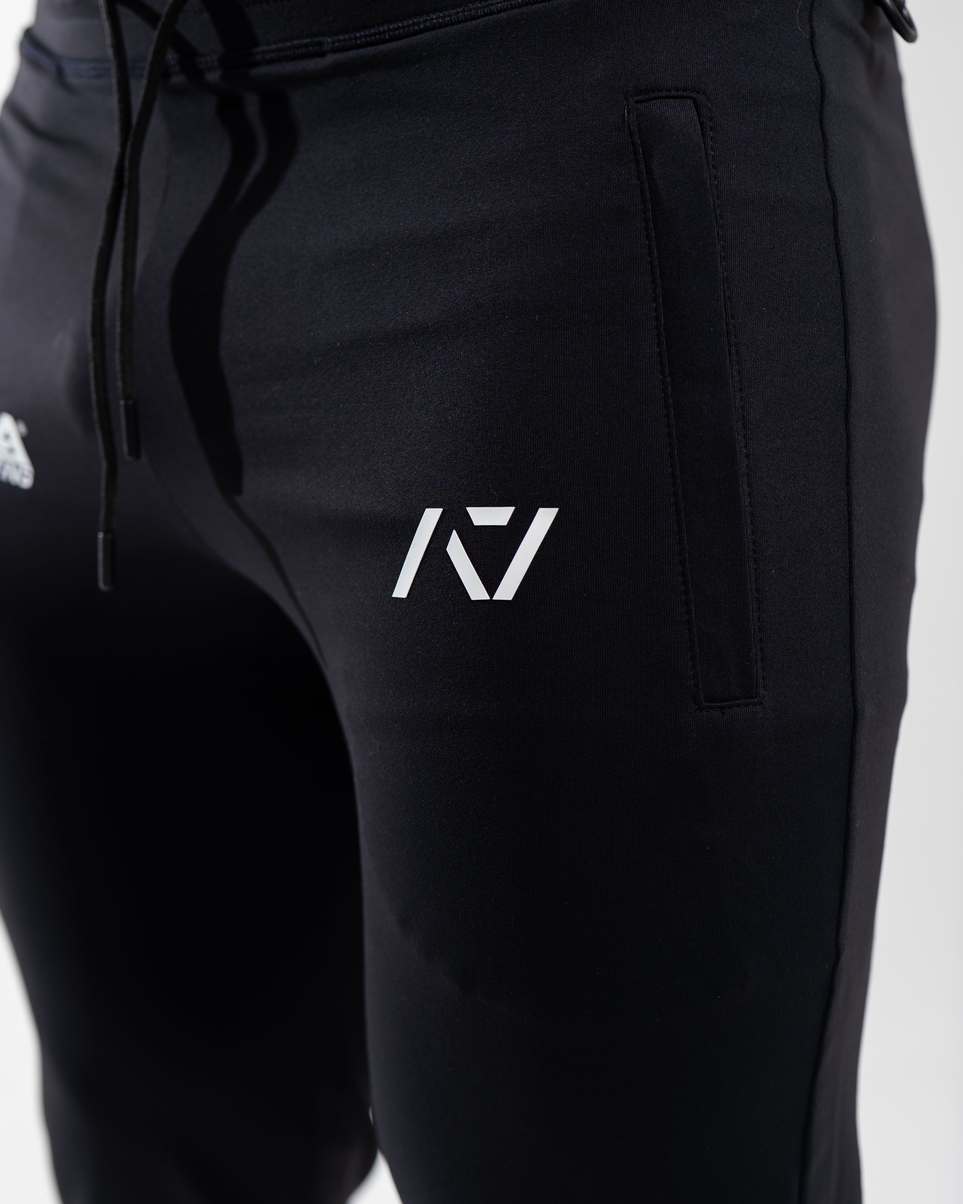 Close-up of the USAPL and A7 silicone logos printed on the front thigh of the joggers.