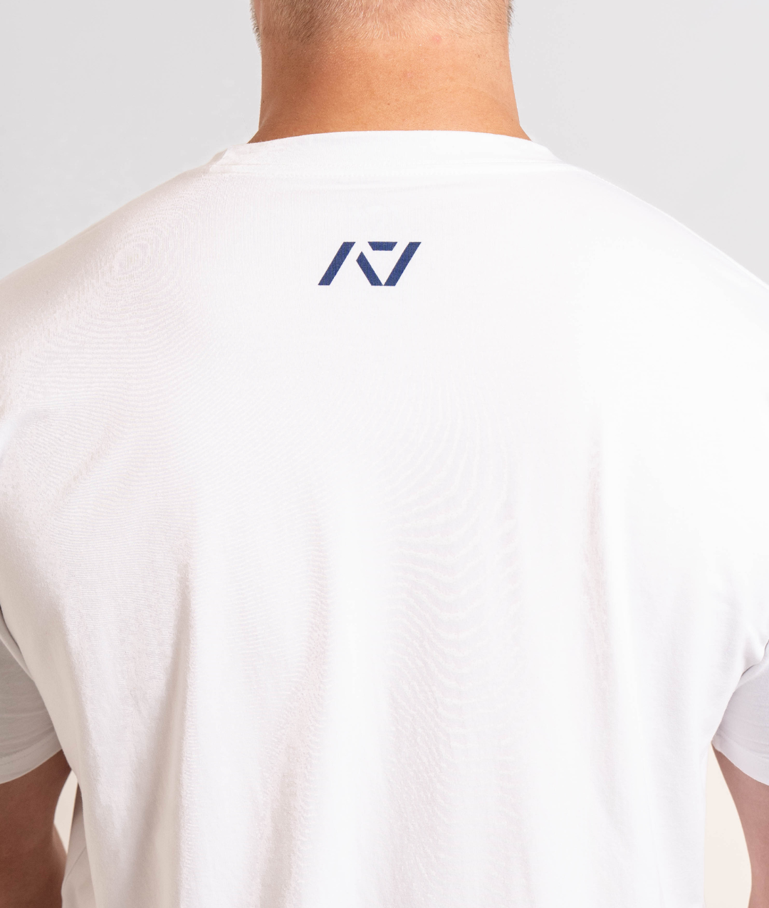 Close-up of the A7 logo printed on the upper back of the Americana True-Fit Meet Shirt, centered just below the neckline.