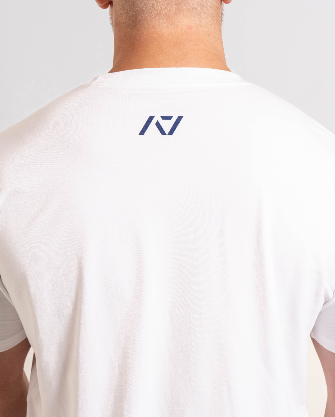 Close-up of the A7 logo printed on the upper back of the Americana True-Fit Meet Shirt, centered just below the neckline.