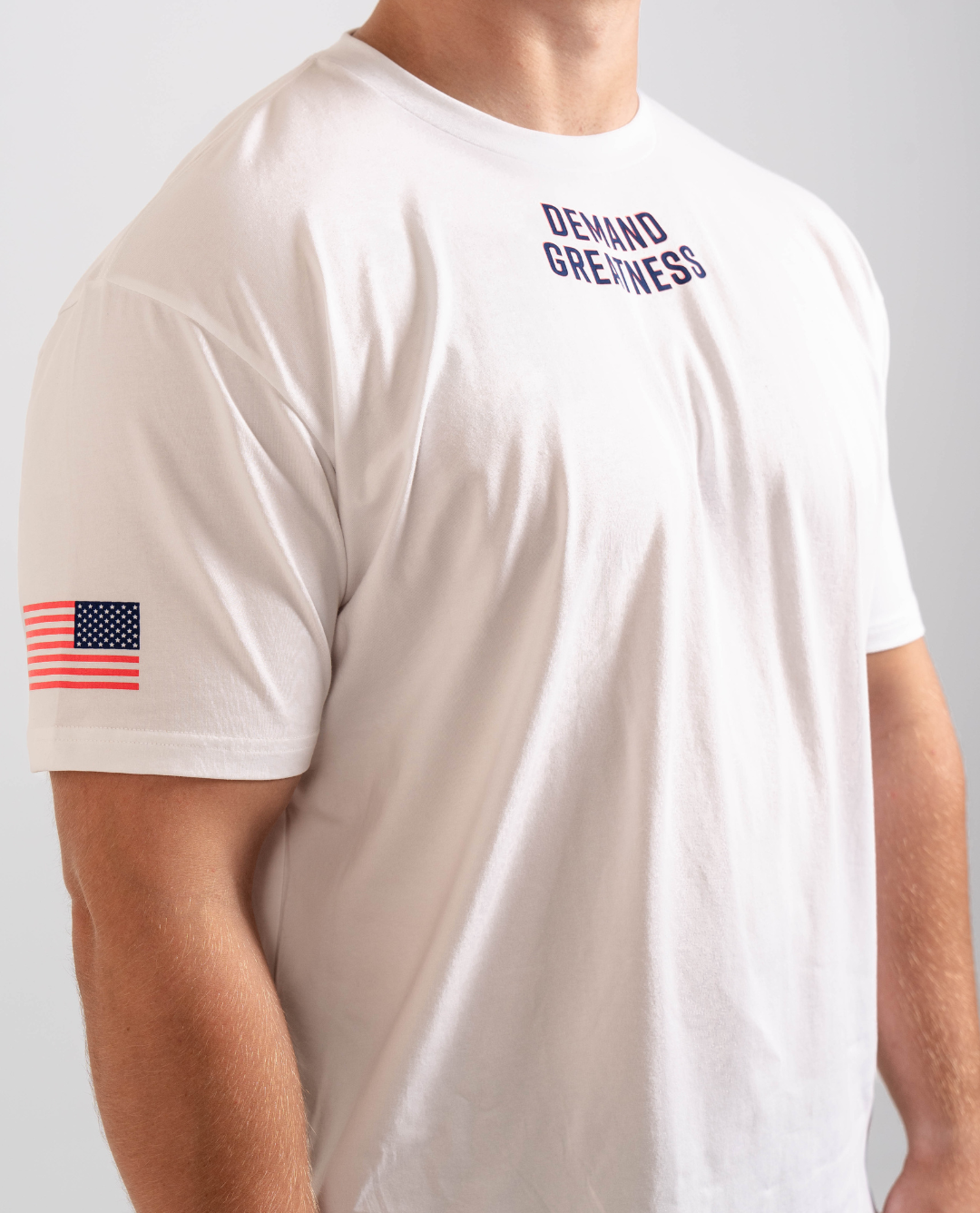 Side view of the Americana True-Fit Meet Shirt highlighting the printed American flag on the sleeve and athletic tapered fit through the torso.
