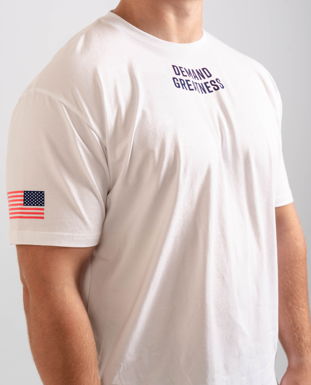 Side view of the Americana True-Fit Meet Shirt highlighting the printed American flag on the sleeve and athletic tapered fit through the torso.