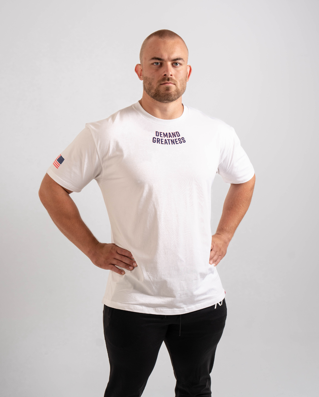 Front view of the Americana True‑Fit Meet Shirt showing “Demand Greatness” chest print.