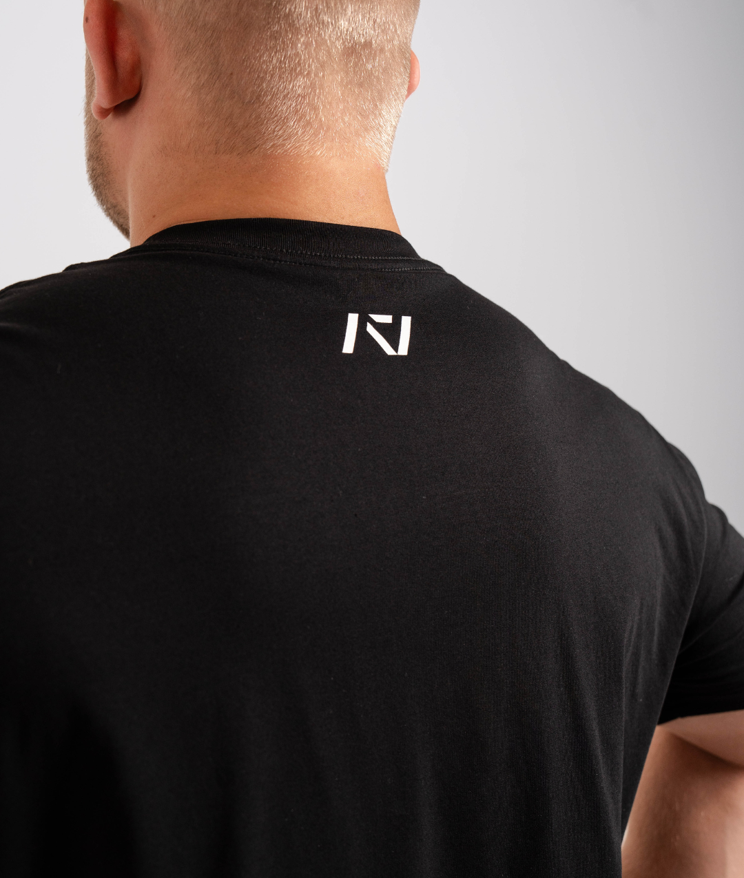Back view highlighting A7 logo printed below the neckline on the Domino shirt.