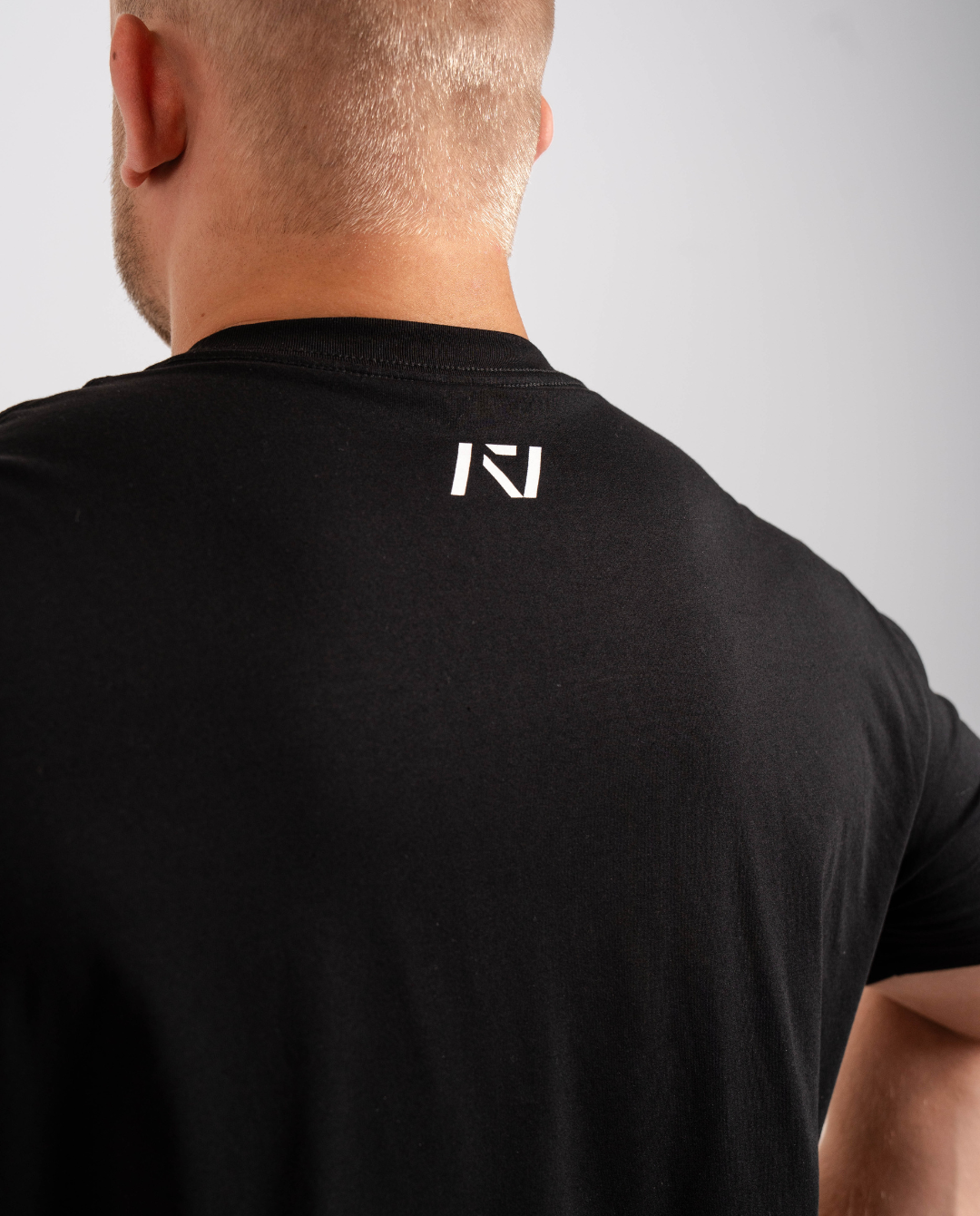 Back view highlighting A7 logo printed below the neckline on the Domino shirt.