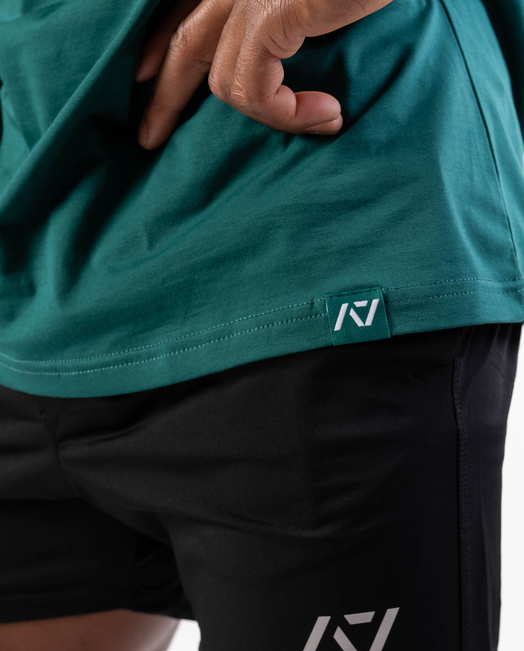 Close-up of woven A7 hem tag along the bottom hem of the shirt.