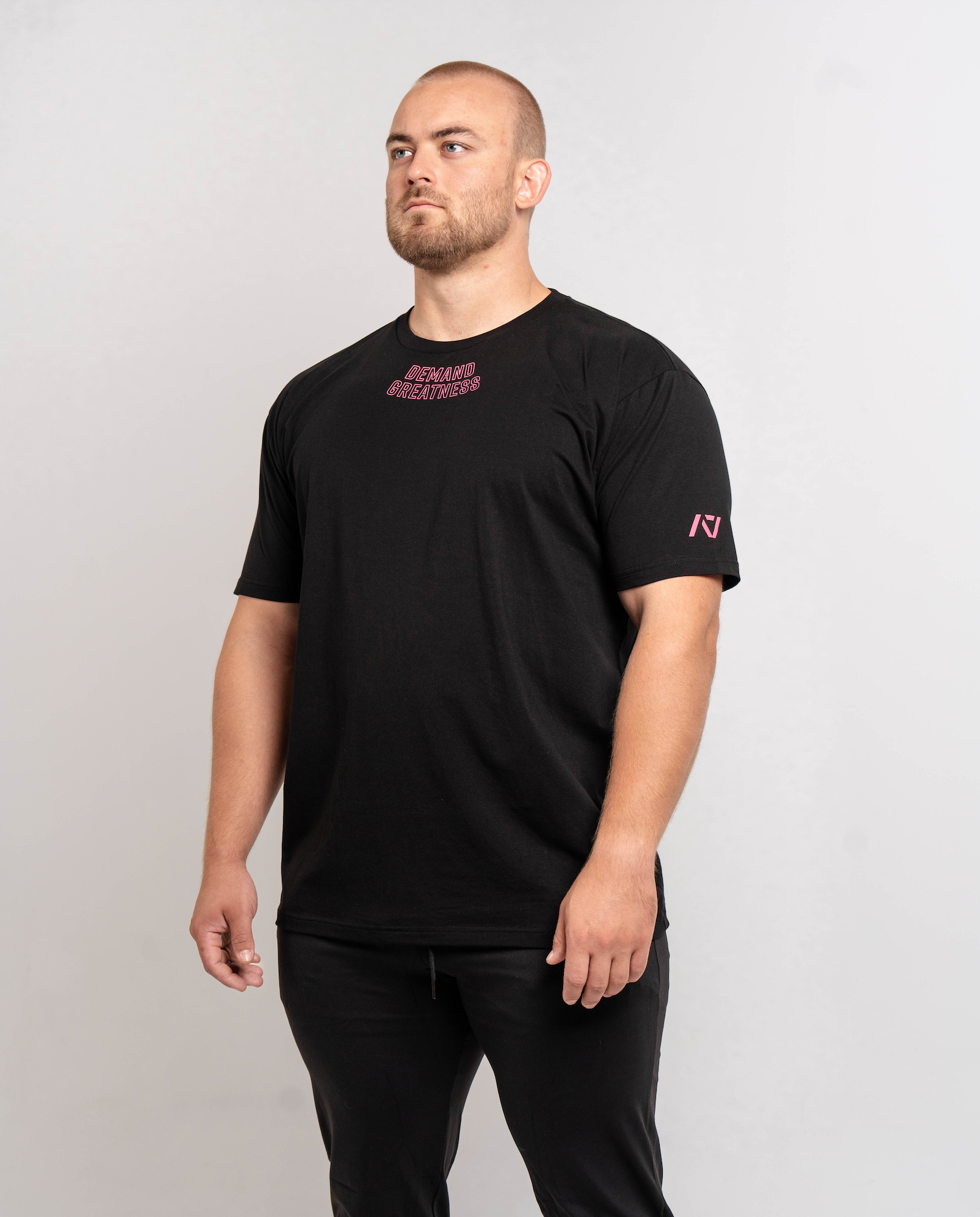 Front view of Flamingo True‑Fit Meet Shirt displaying “Demand Greatness” chest print and athletic torso fit.