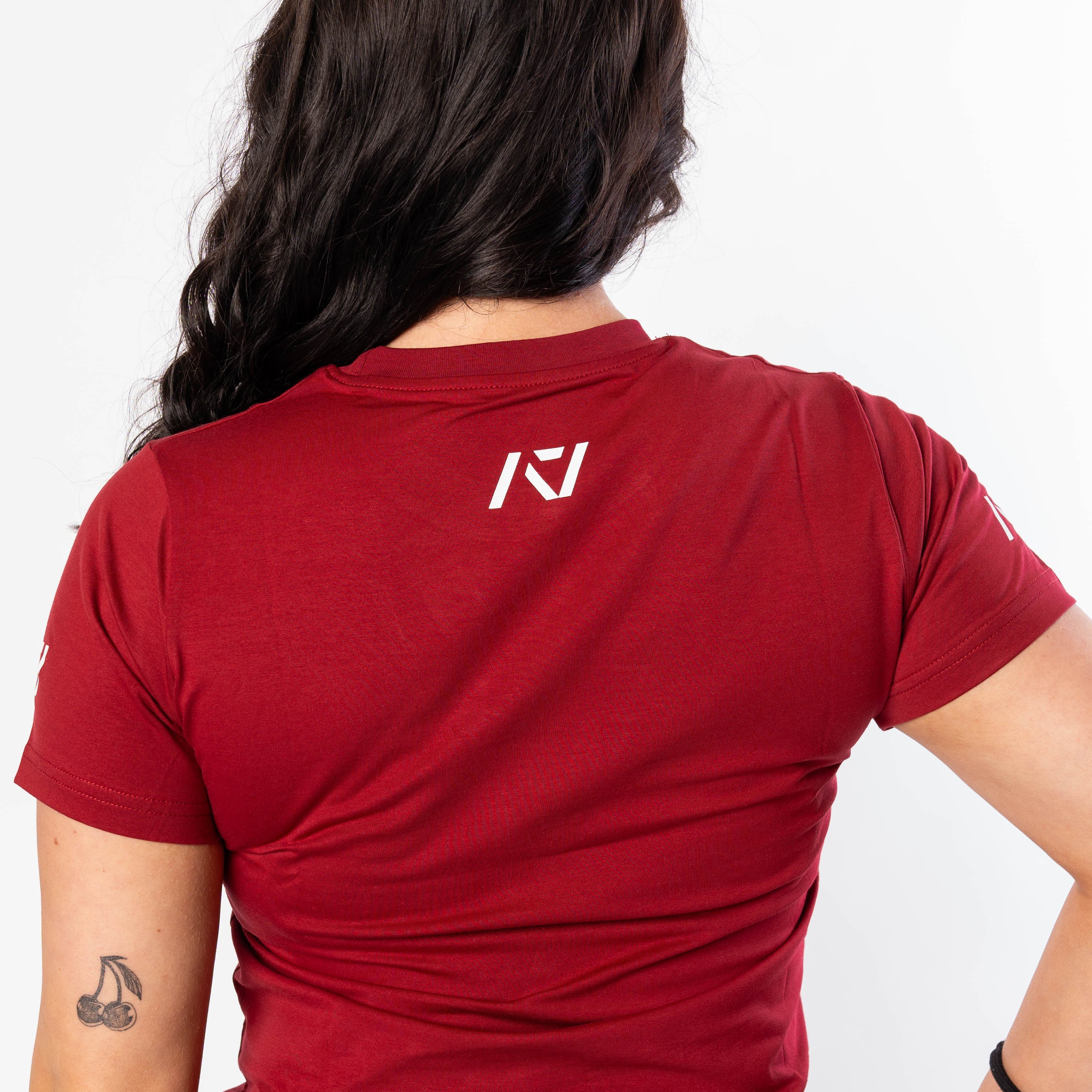 A7 logo on the upper back to show underneath a singlet on red women's meet shirt