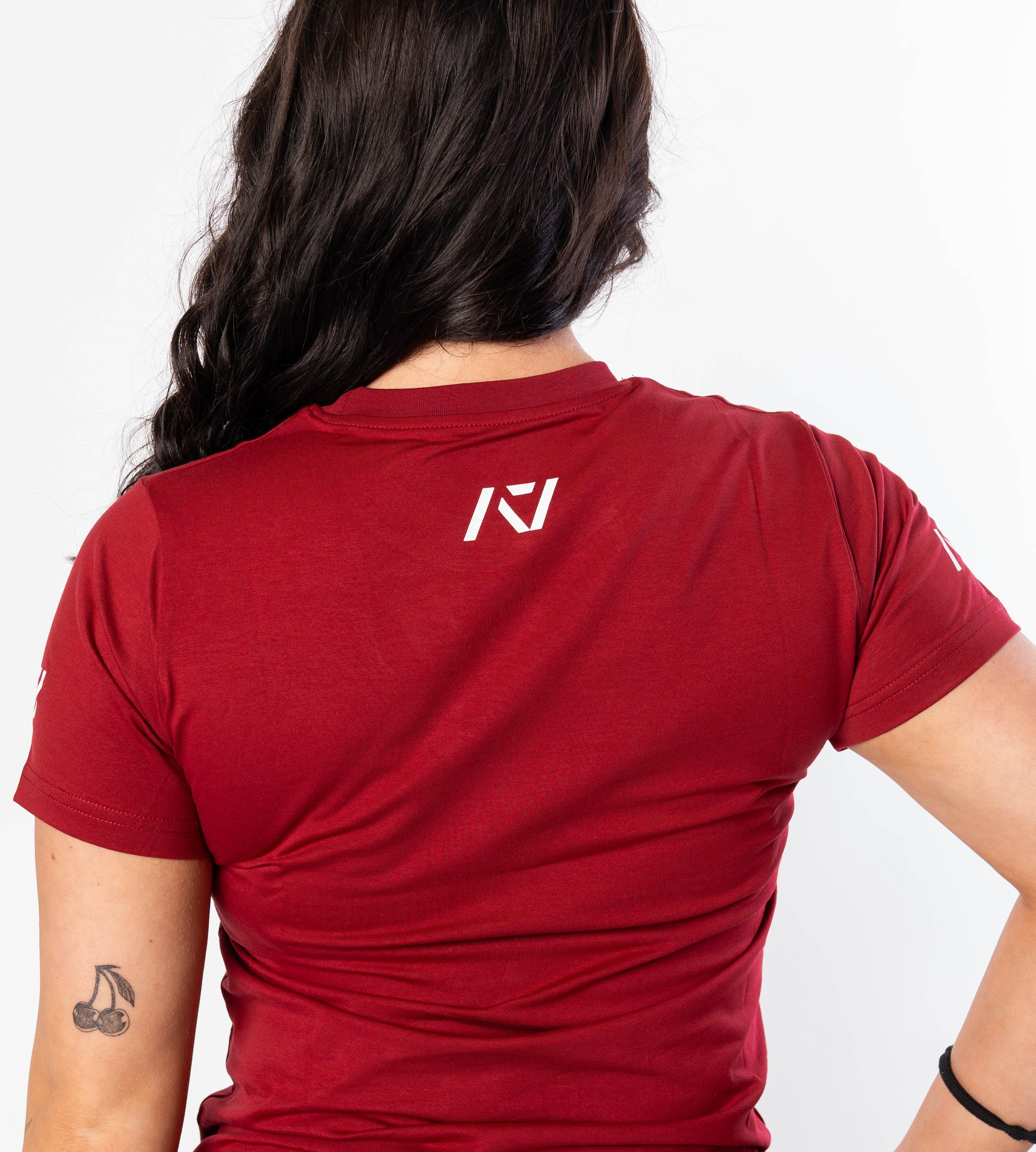 A7 logo on the upper back to show underneath a singlet on red women's meet shirt