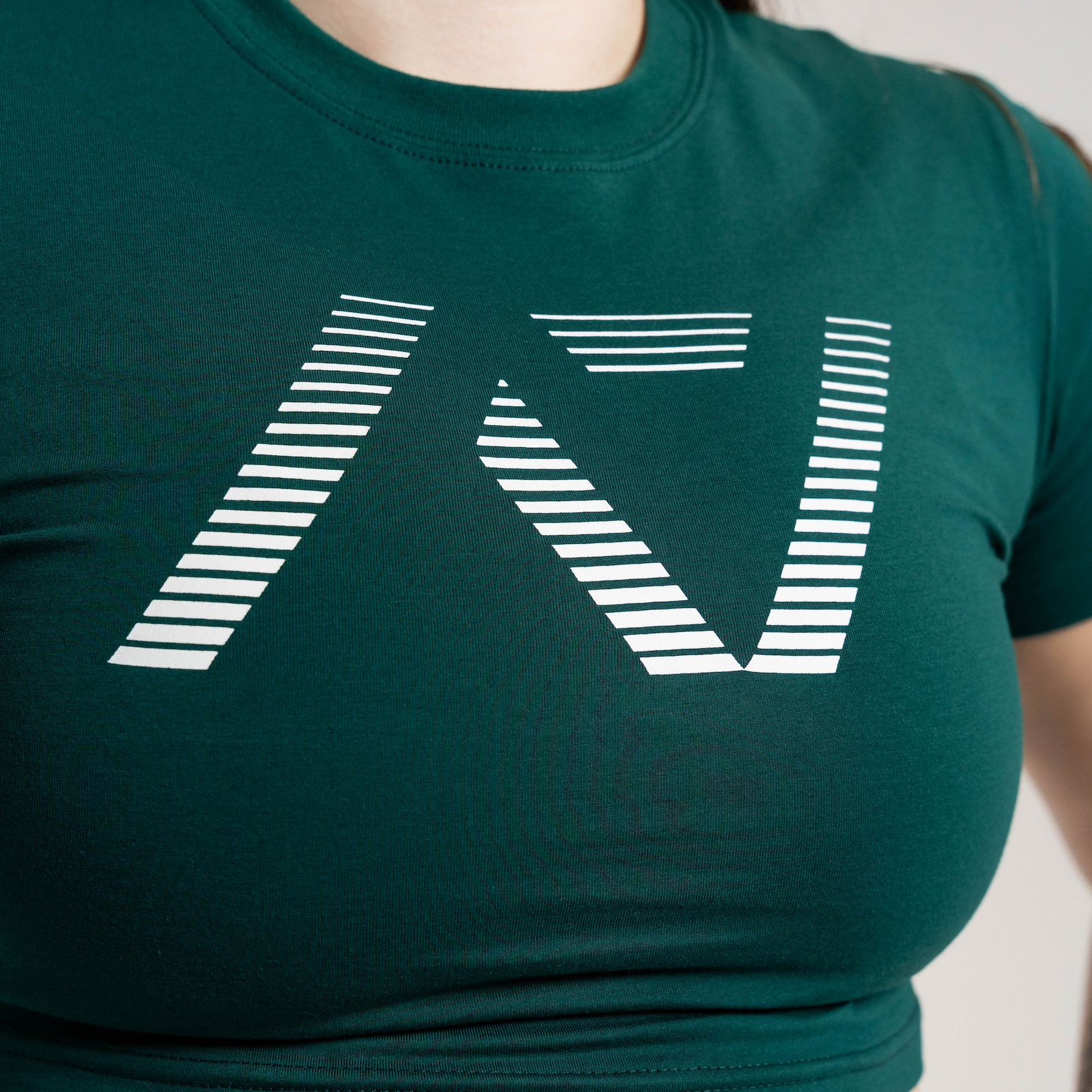 Green crop top with a white geometric design on a neutral background