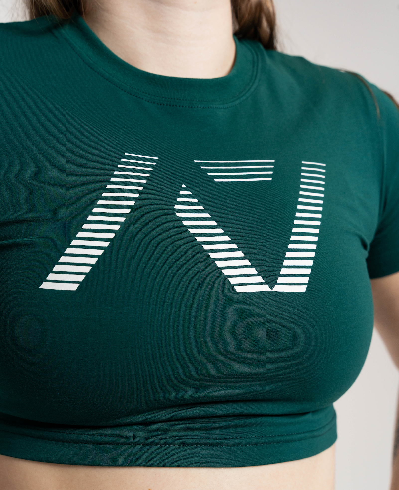 Green crop top with a white geometric design on a neutral background