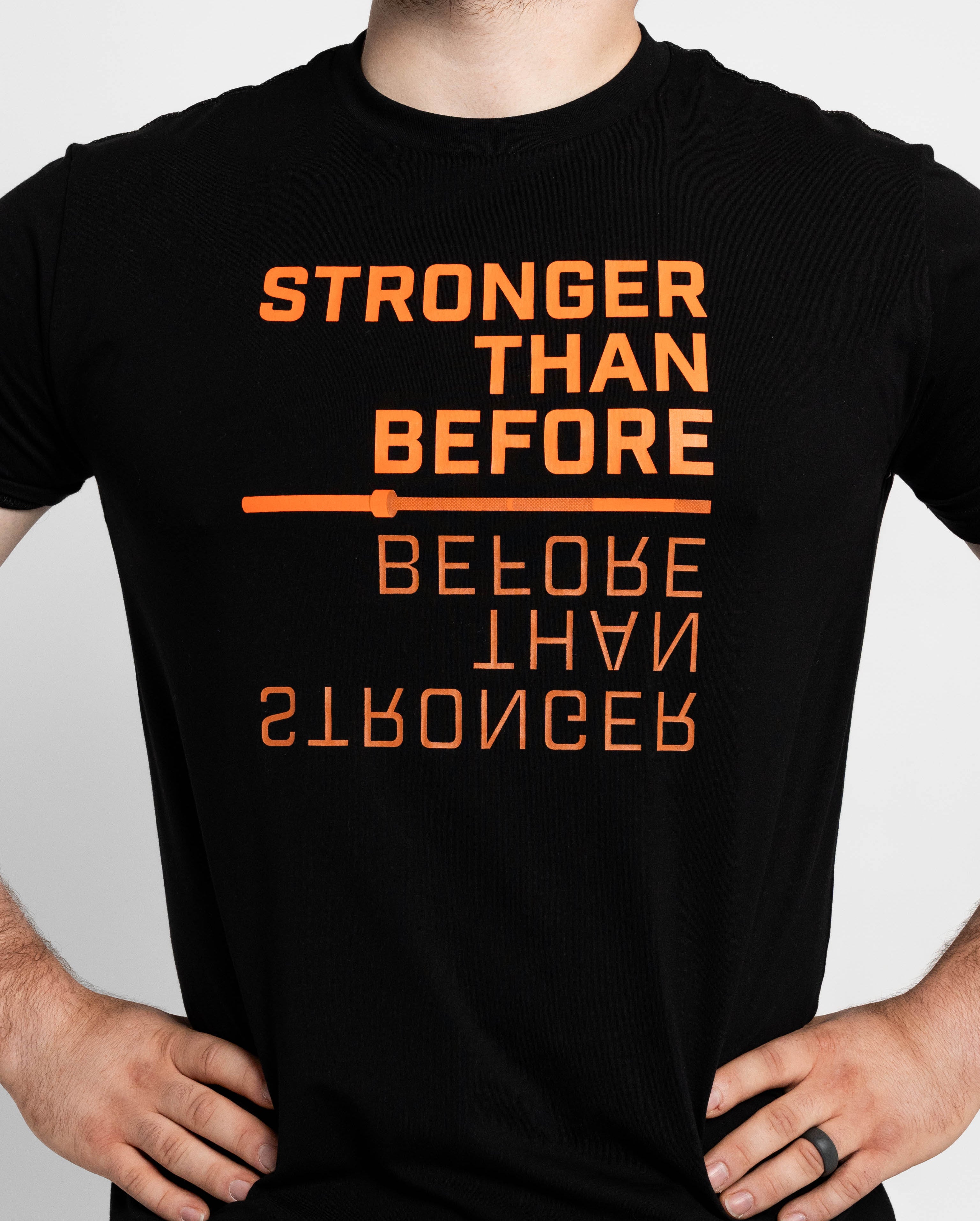 Black t-shirt with orange motivational text on a plain background