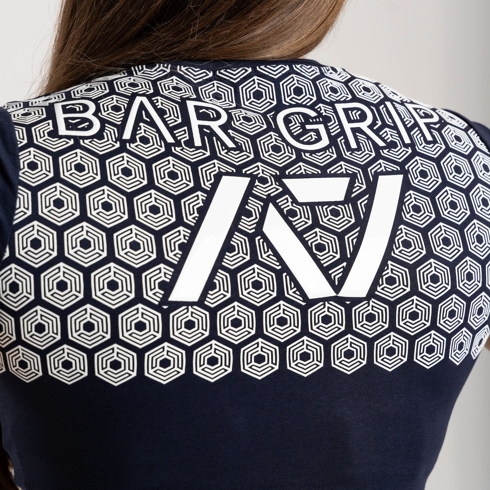close up of navy through time bar grip shirt of back