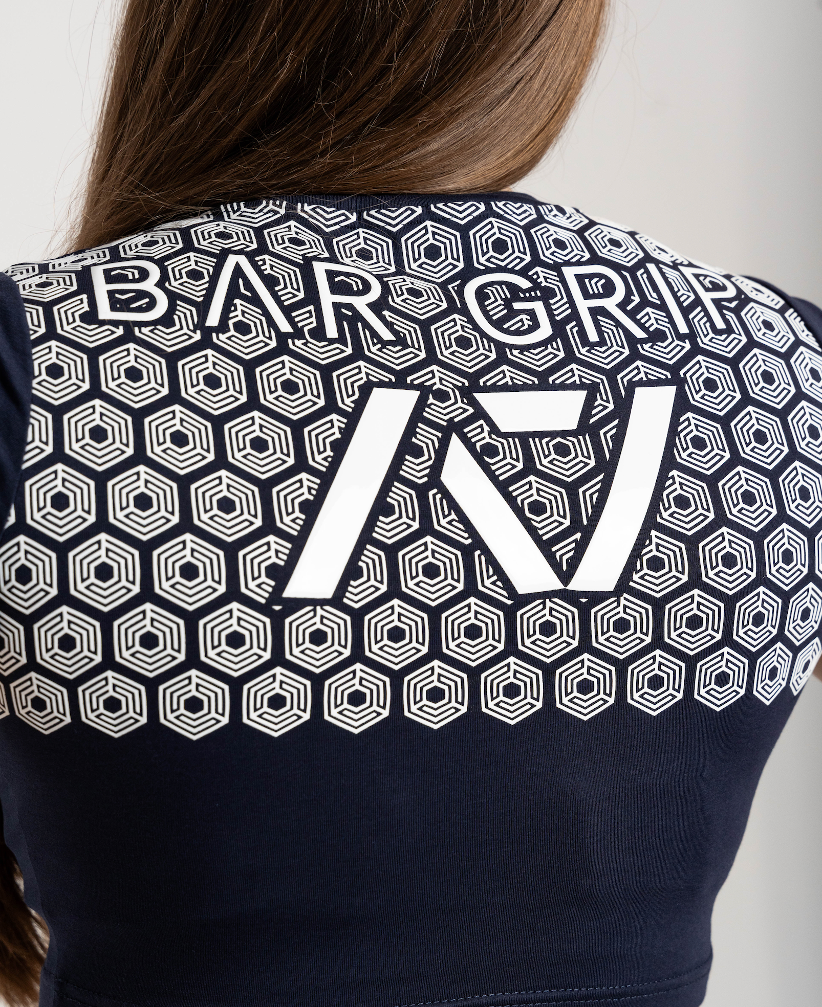 close up of navy through time bar grip shirt of back