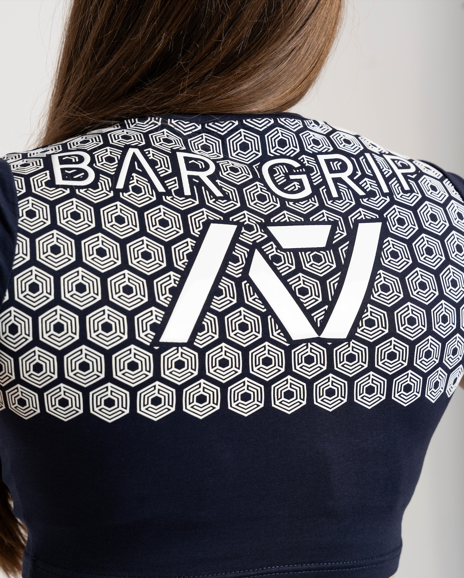 close up of navy through time bar grip shirt of back