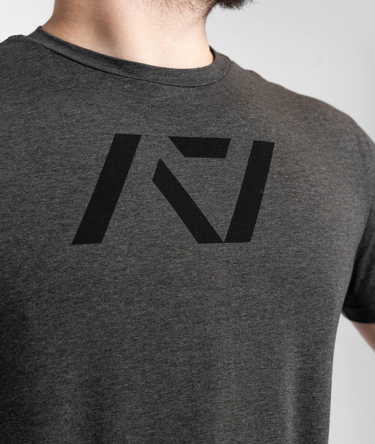Gray t-shirt with a black logo on a plain background