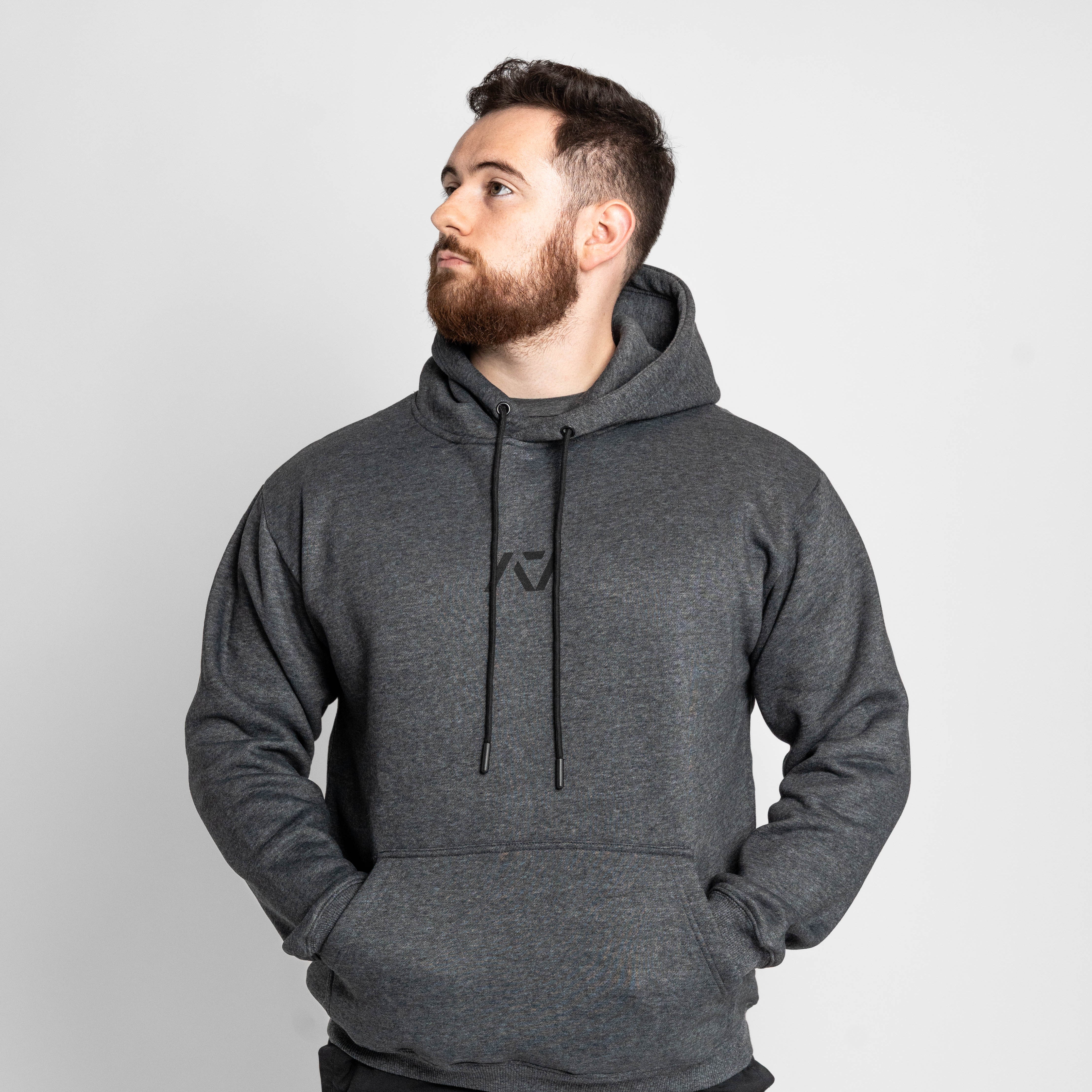 Man wearing a gray hoodie with a logo on a white background
