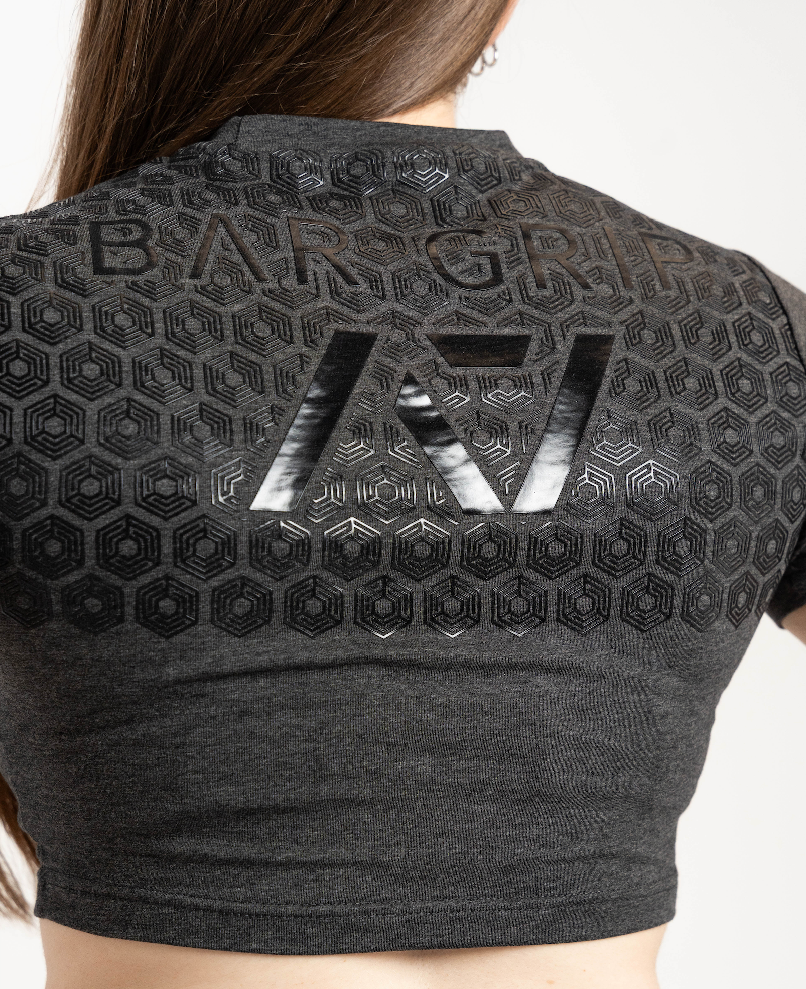 Black crop top with a7 bar grip and branding on a white background
