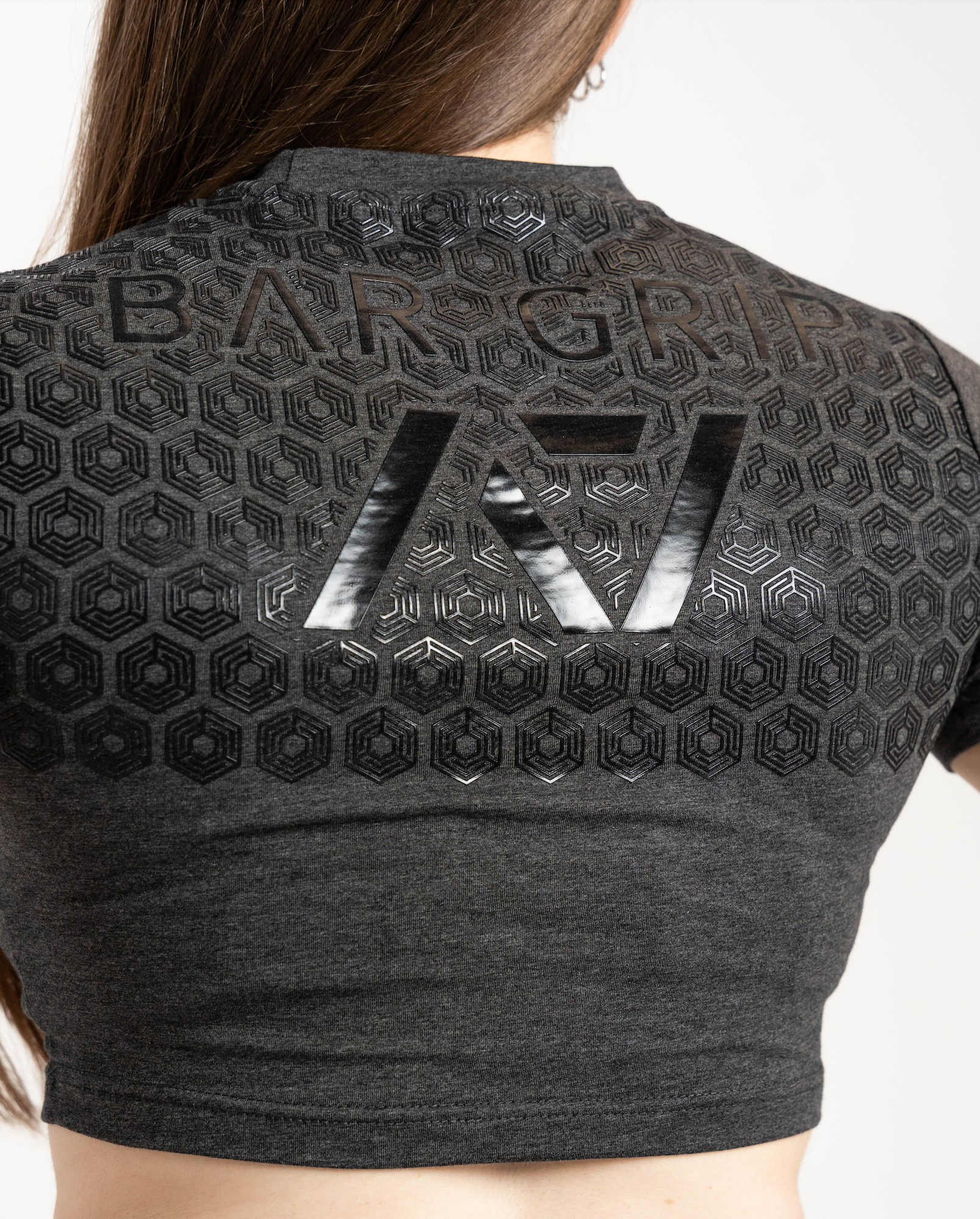 Black crop top with a7 bar grip and branding on a white background
