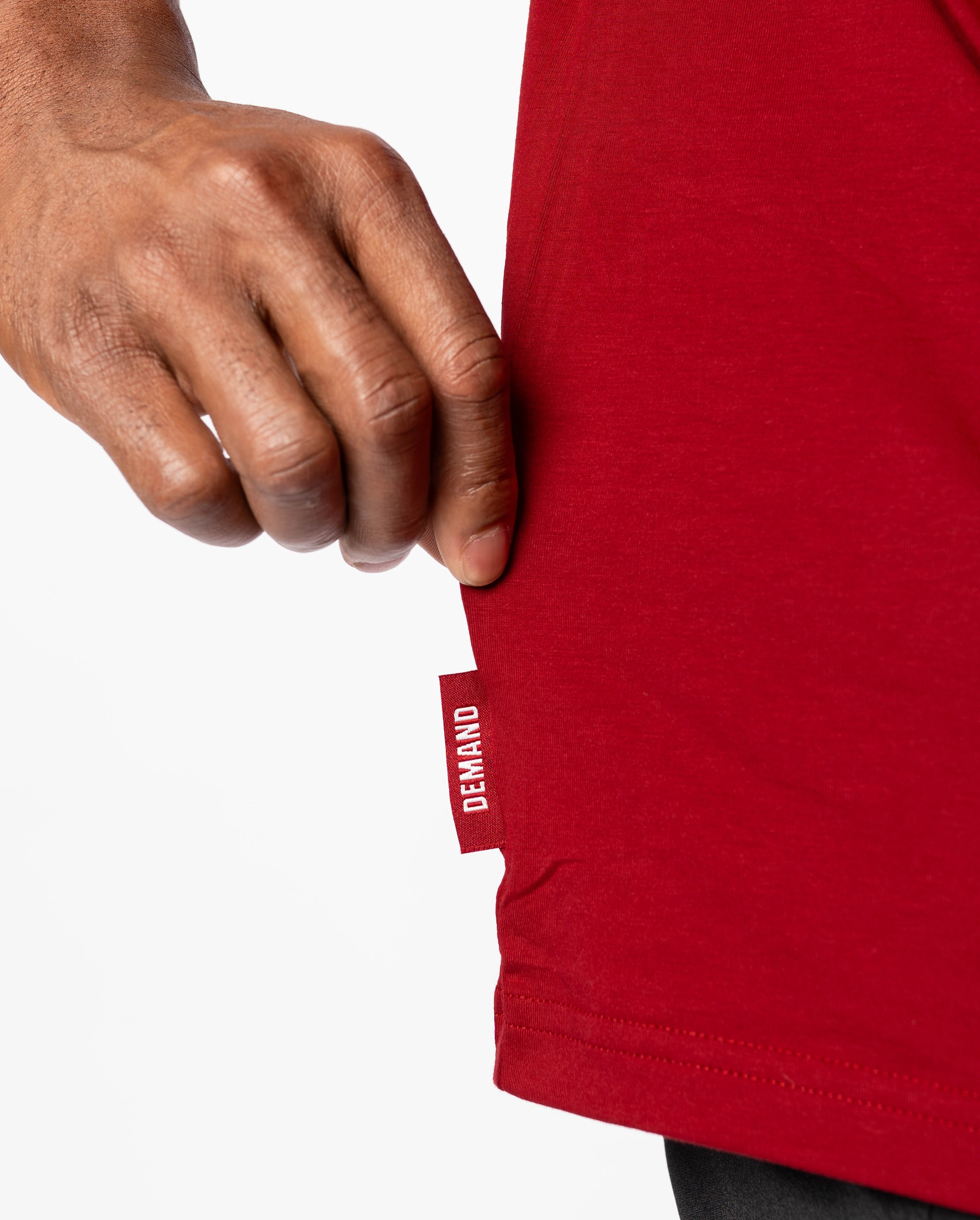 Close up of Demand Greatness side hem tag