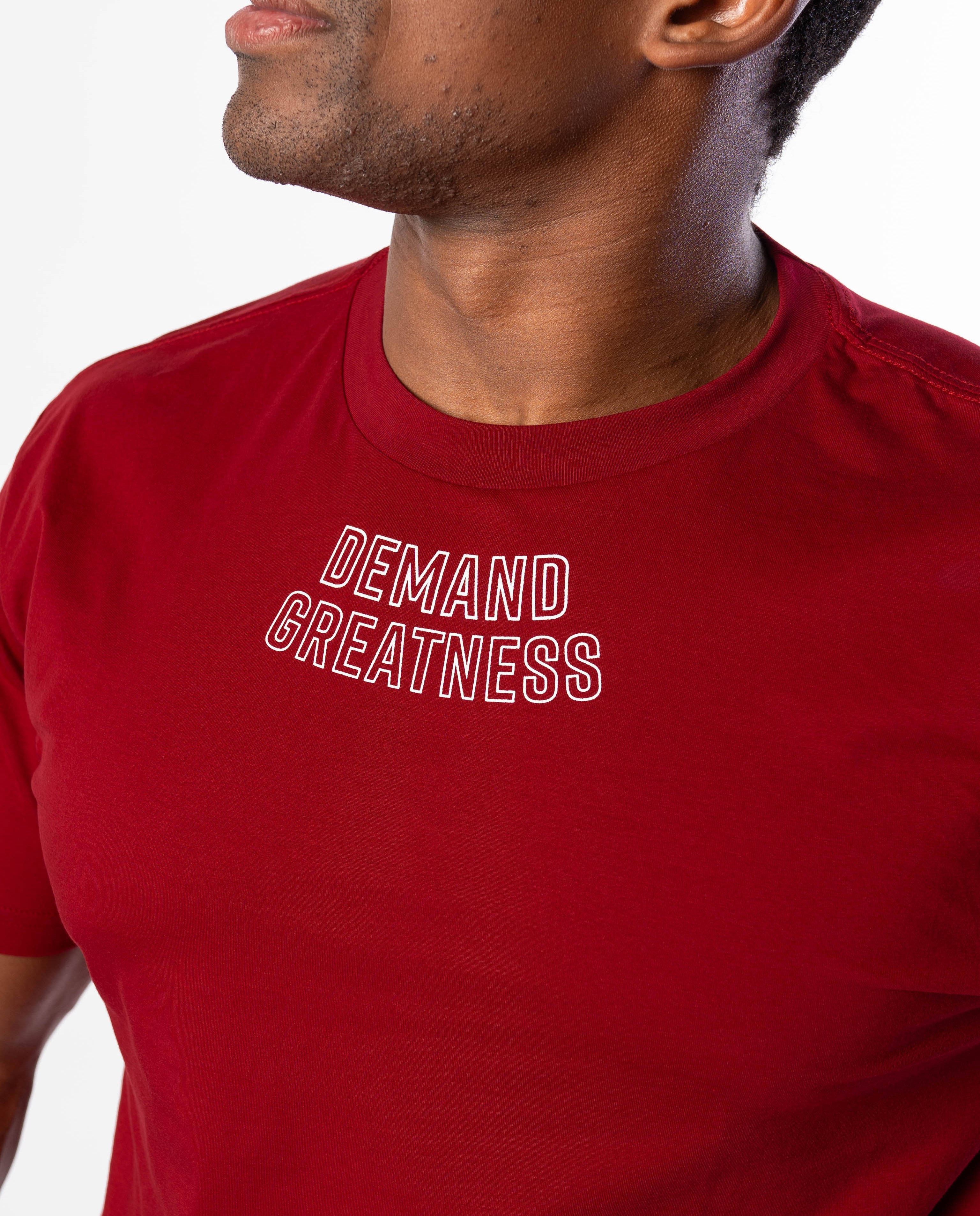Close up of DEMAND GREATNESS text on the upper center chest of A7 meet shirt in red
