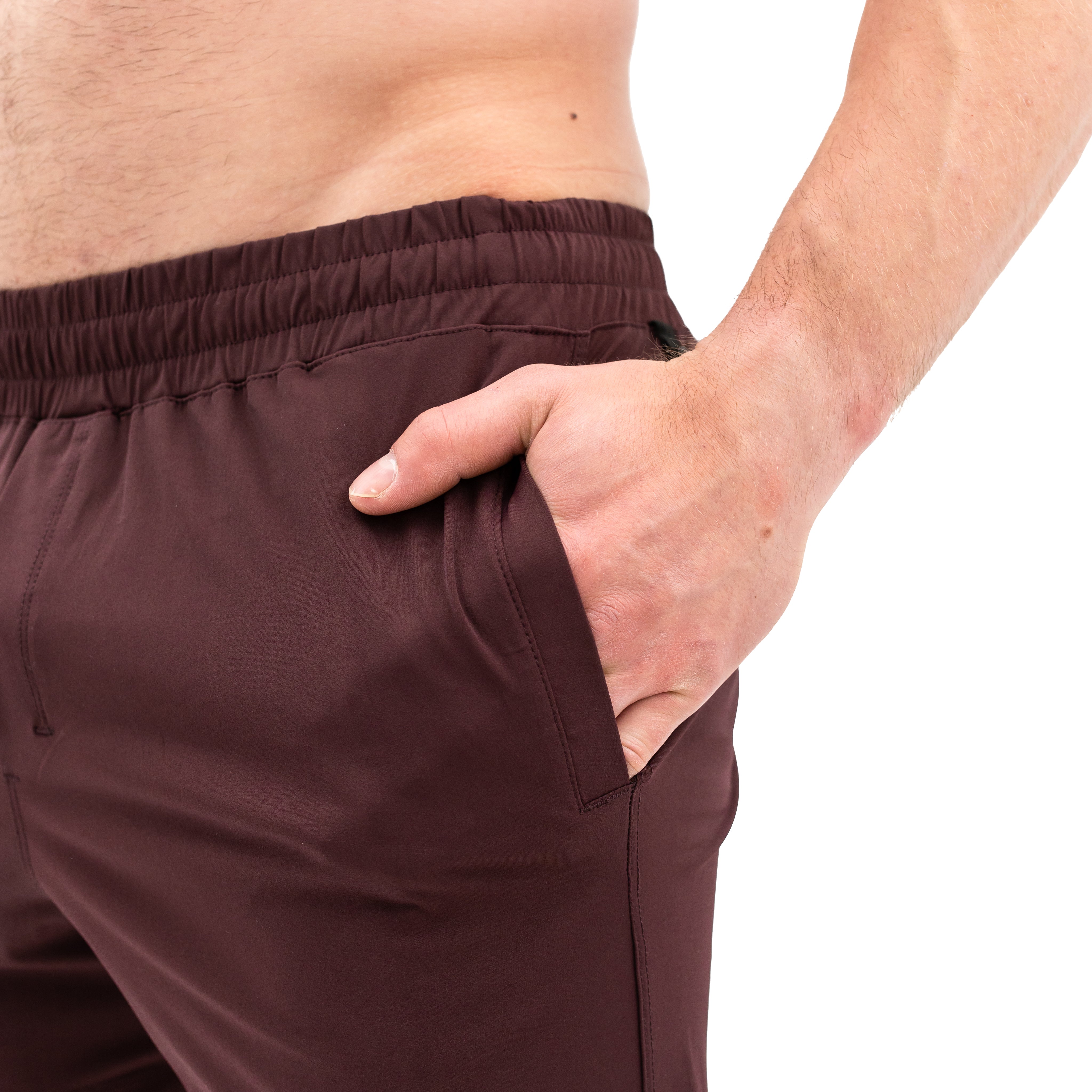 Close-up of ripstop nylon pocket and hidden wallet pocket on Mahogany 360Go Shorts for secure storage during workouts.