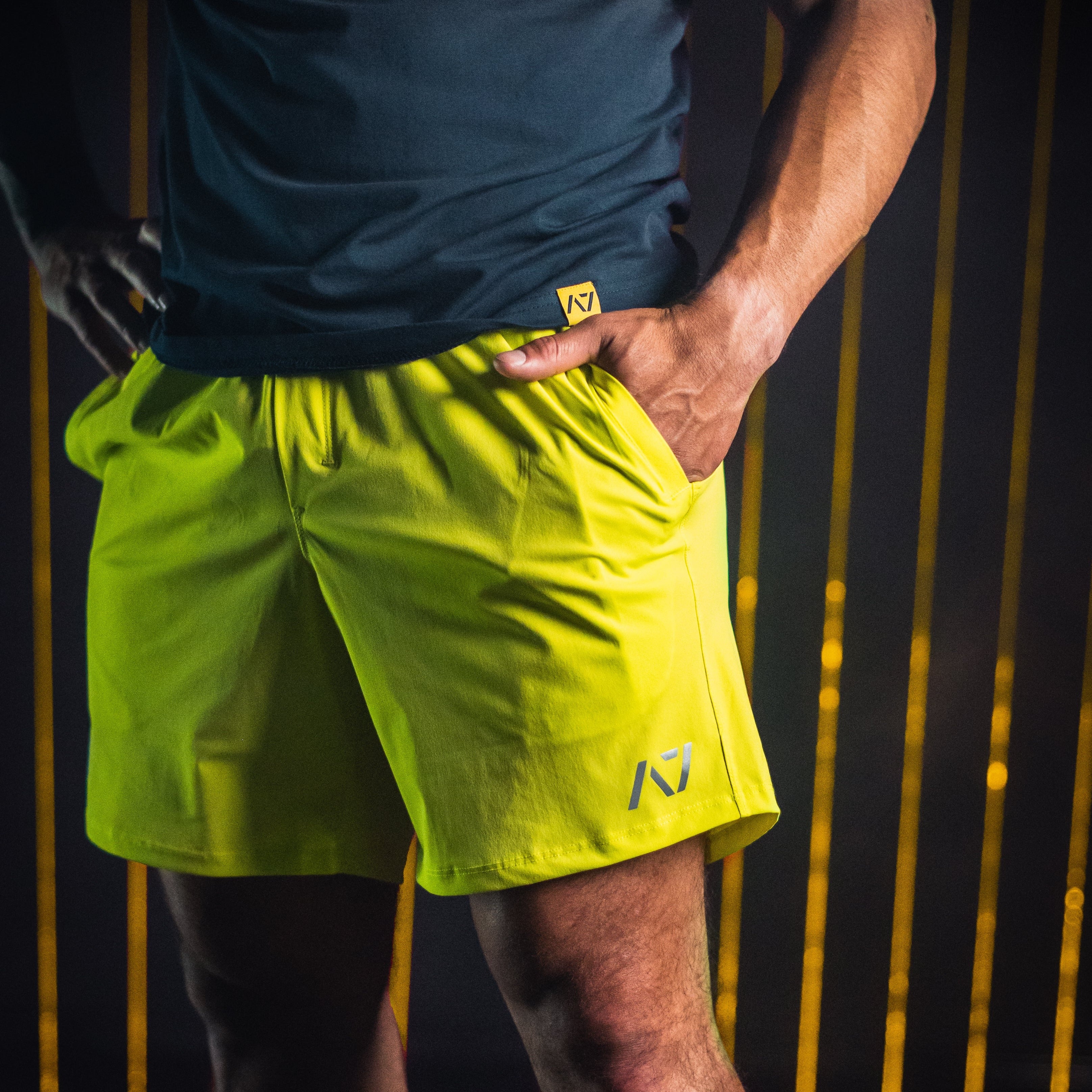 Side profile of Electric Lemonade 360Go Shorts showing extended inseam and flexible stretch material for training mobility.