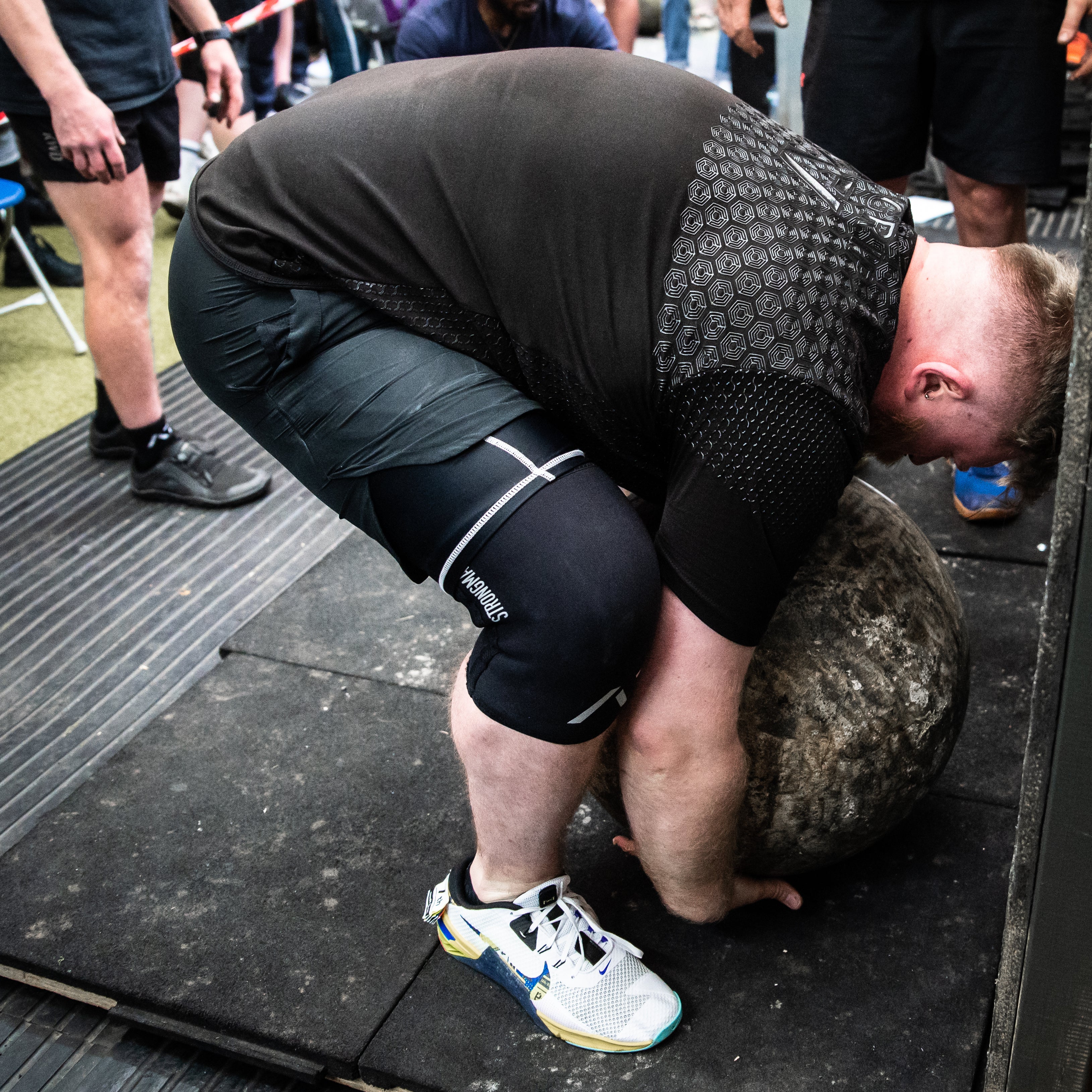 Athlete competing in strongman with A7 Strongman Knee Sleeves – 9mm – Black/Reflective