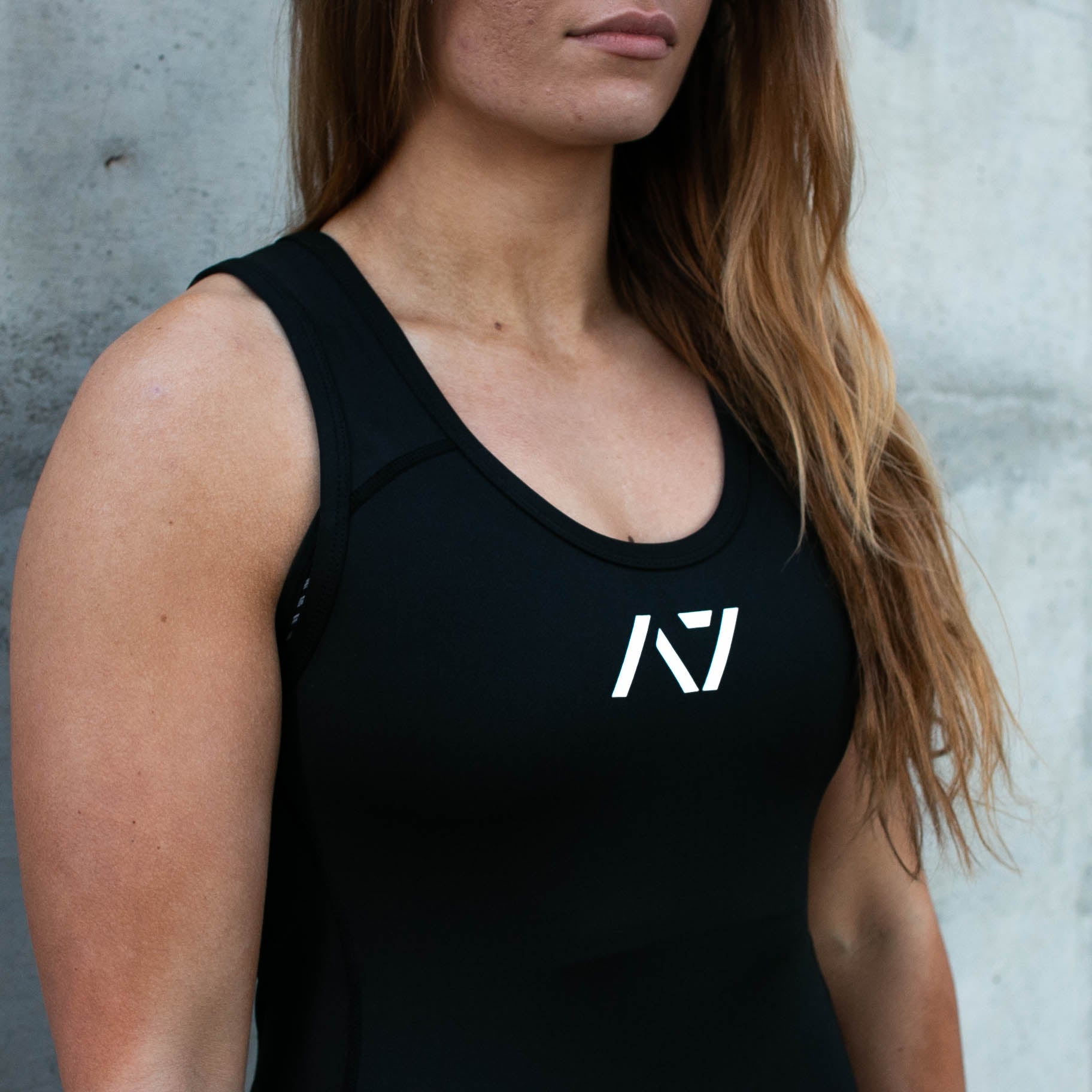 Close-up of the A7 logo on the Classic Black Singlet, featuring subtle branding for a clean, professional competition look.