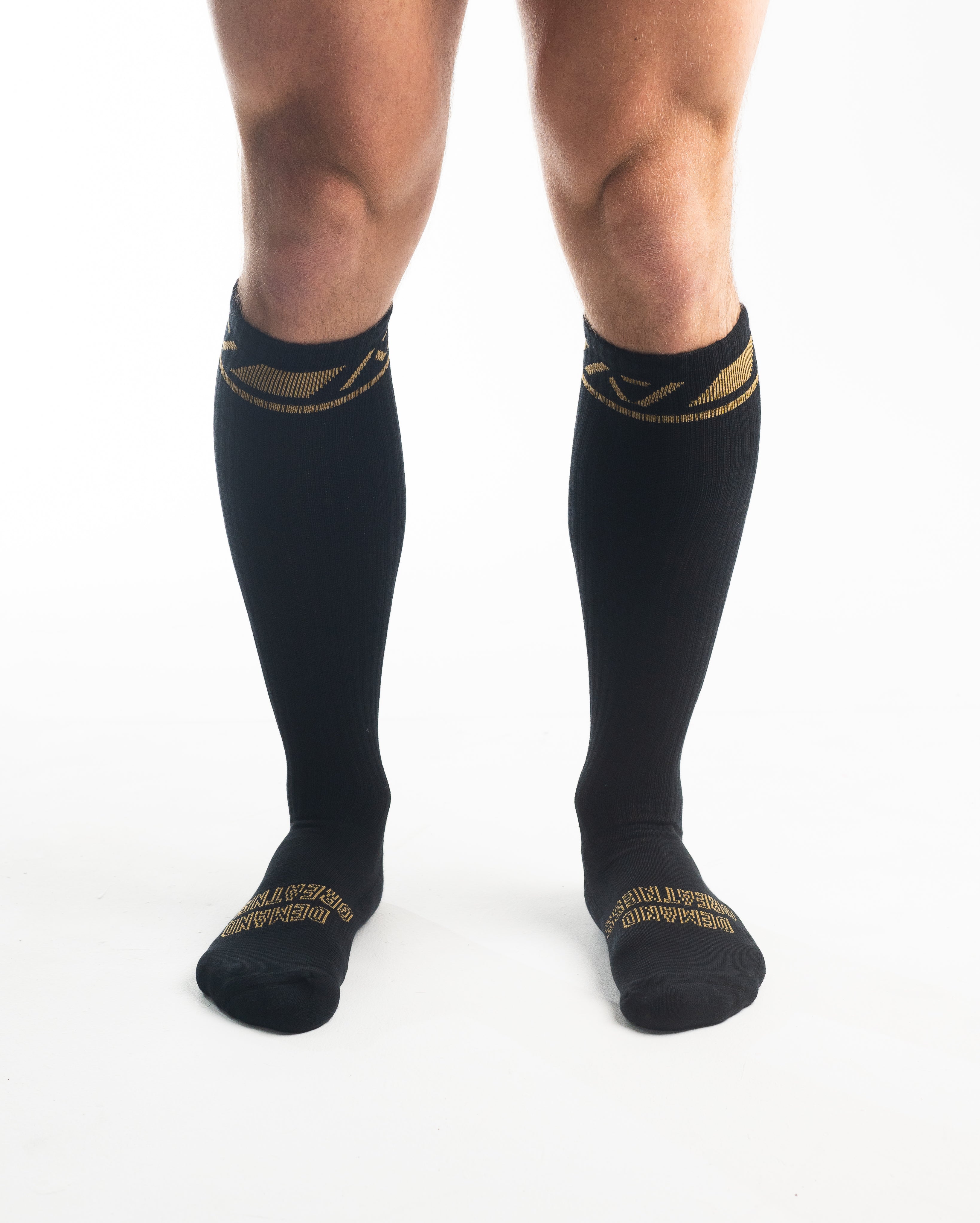 Front view of A7 Deadlift Socks in Gold Standard, showcasing knee-high length and ribbed cuff design.