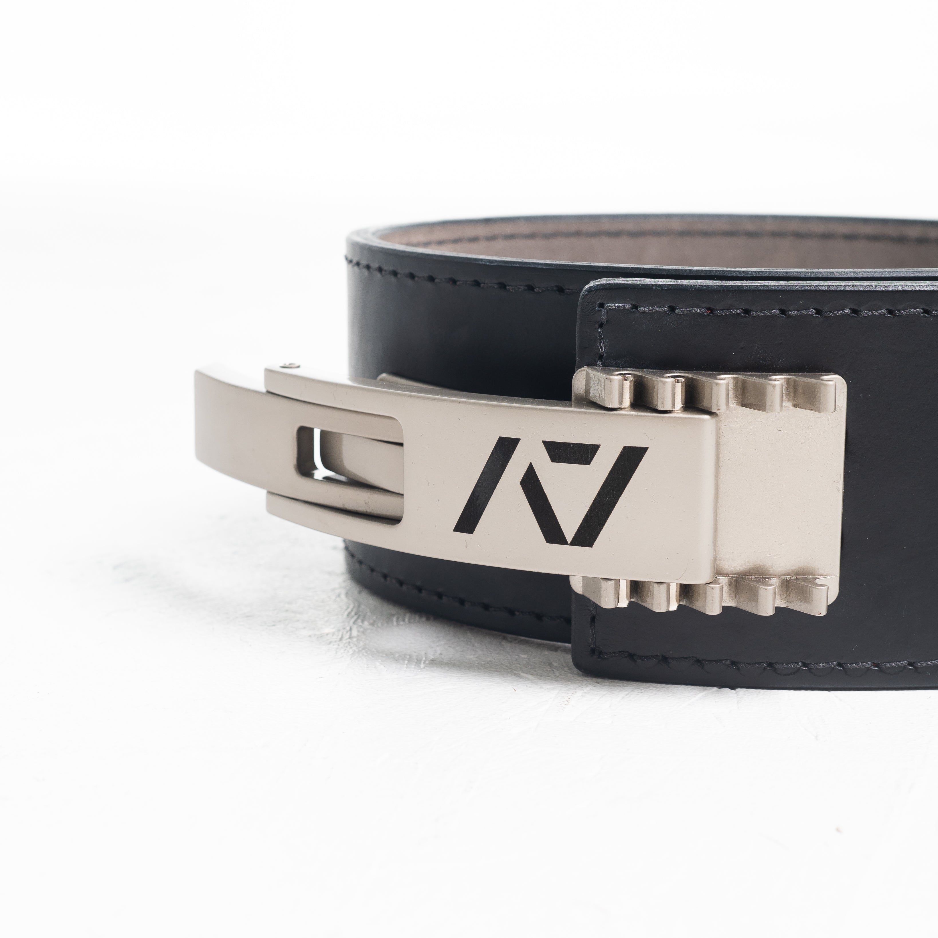 Close up of A7 PAL Buckle in silver mounted on a leather lifting belt, showing compatibility and adjustable fit.