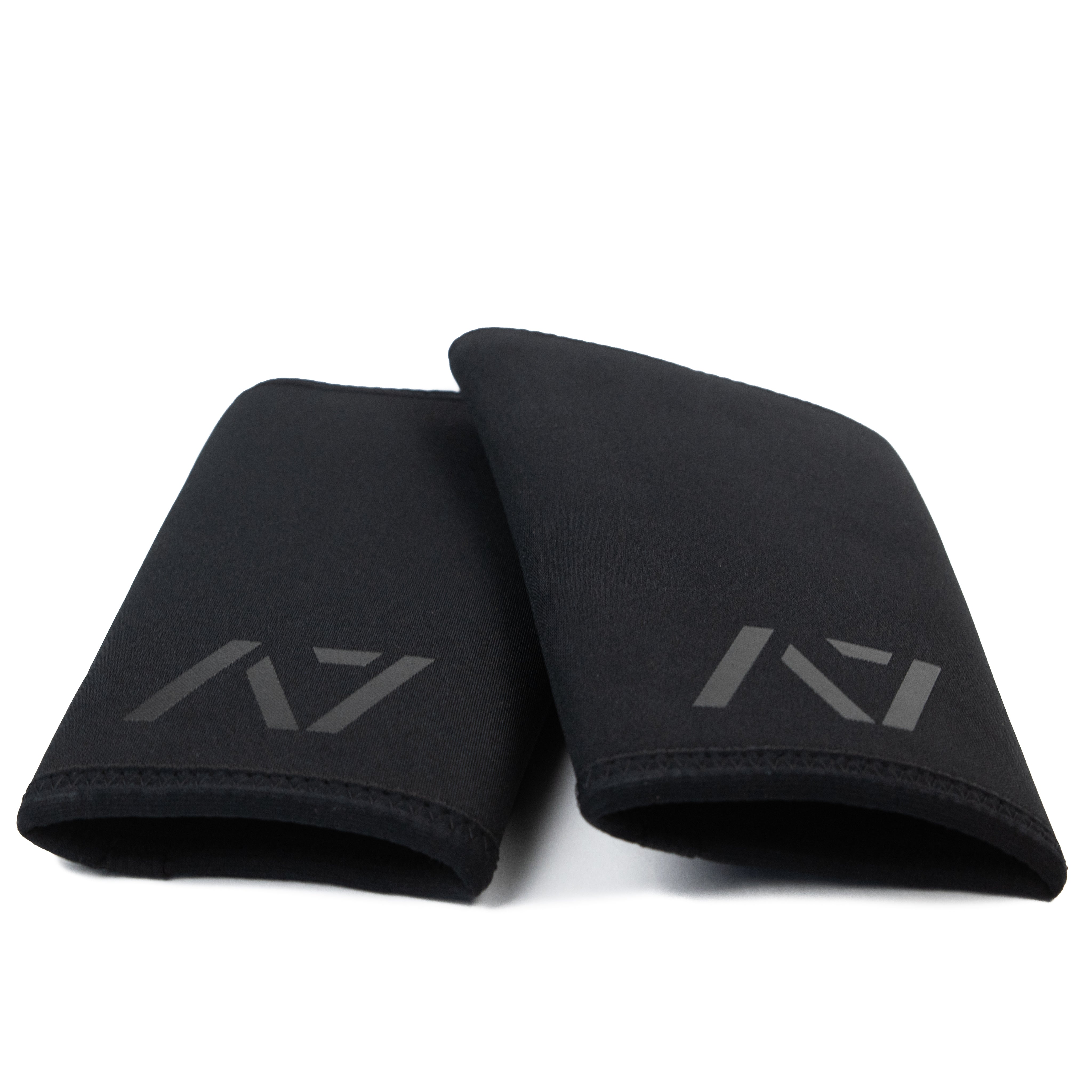 Flat lay of A7 Stealth Stiff CONE Knee Sleeves showing pair side-by-side in black colorway with tapered cut and double rear seams.