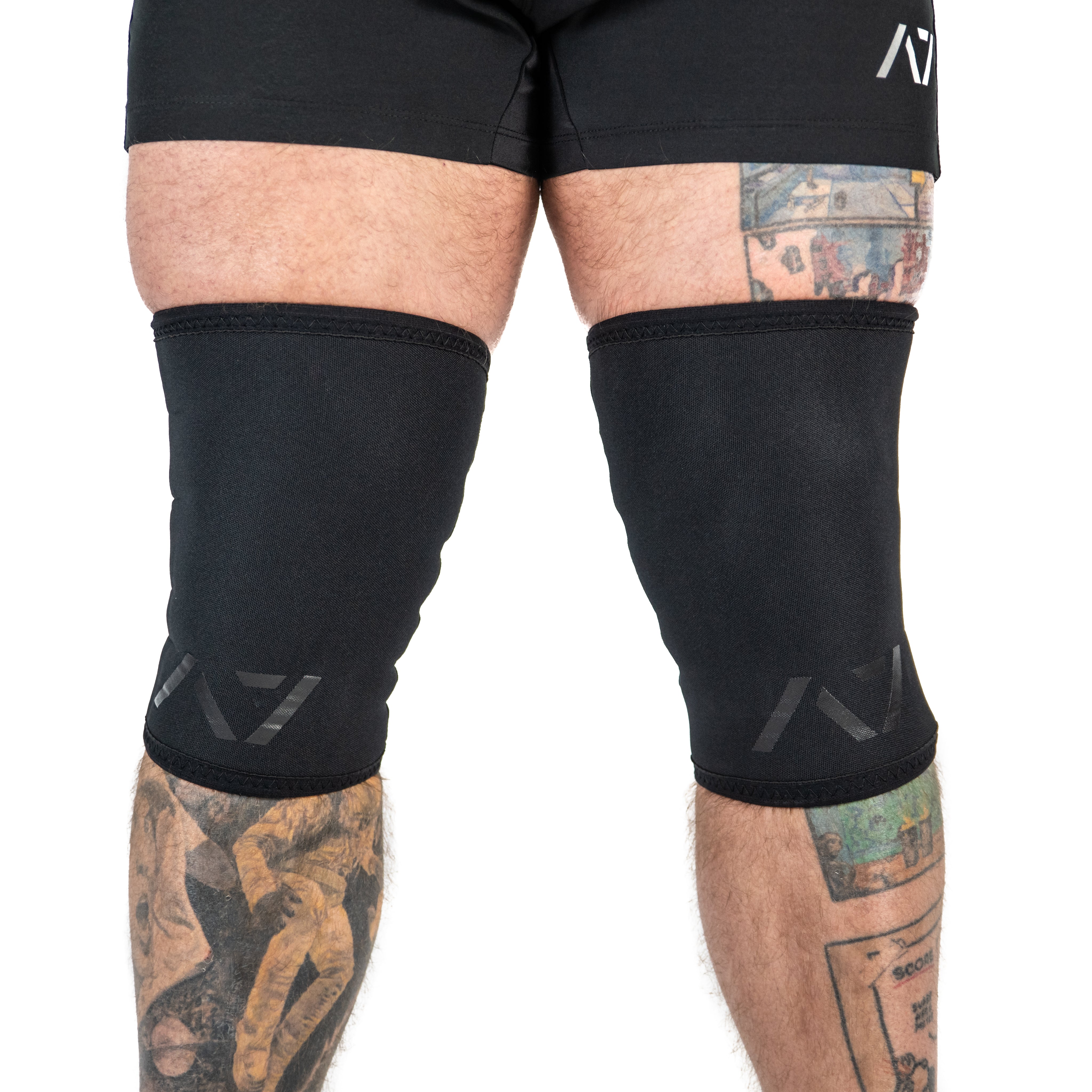 Front view of A7 Stealth Stiff CONE Knee Sleeves showcasing sleek black design and tapered fit.