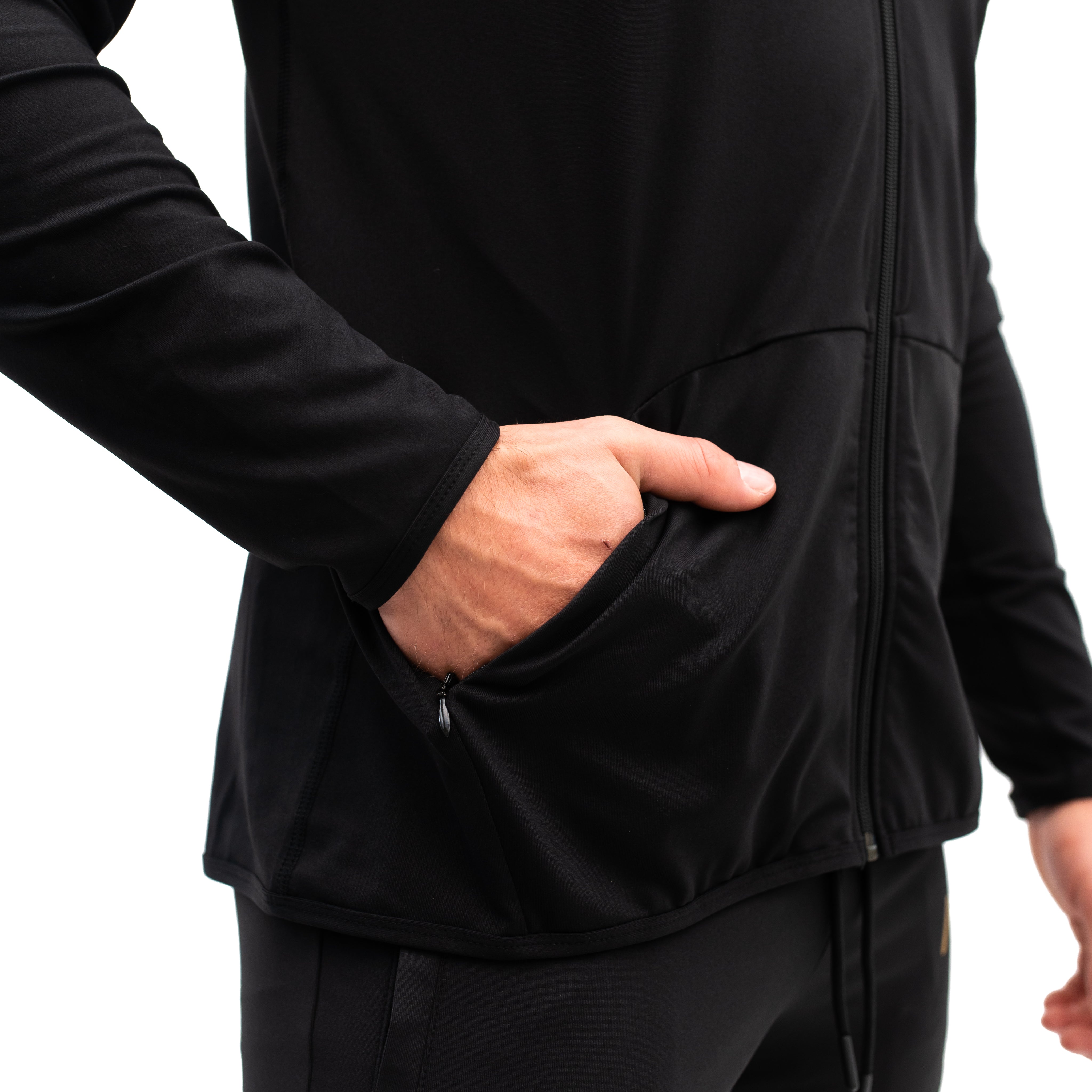 Close-up of the concealed zipper pocket on the Defy Jacket – Gold Standard, highlighting the matte zipper and soft 4-way stretch fabric for secure storage and comfort.