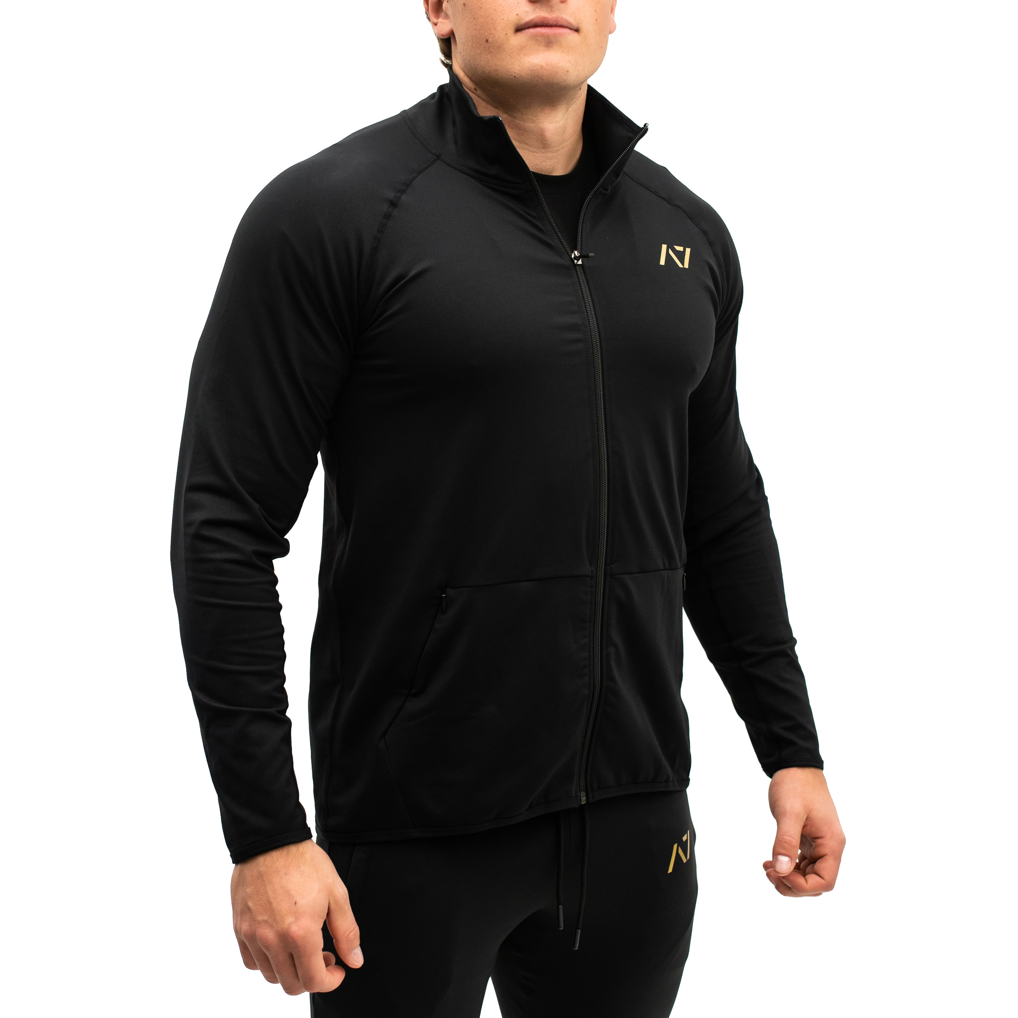 Side profile showing the tapered fit and sleeve lines of the Gold Standard Defy Jacket.