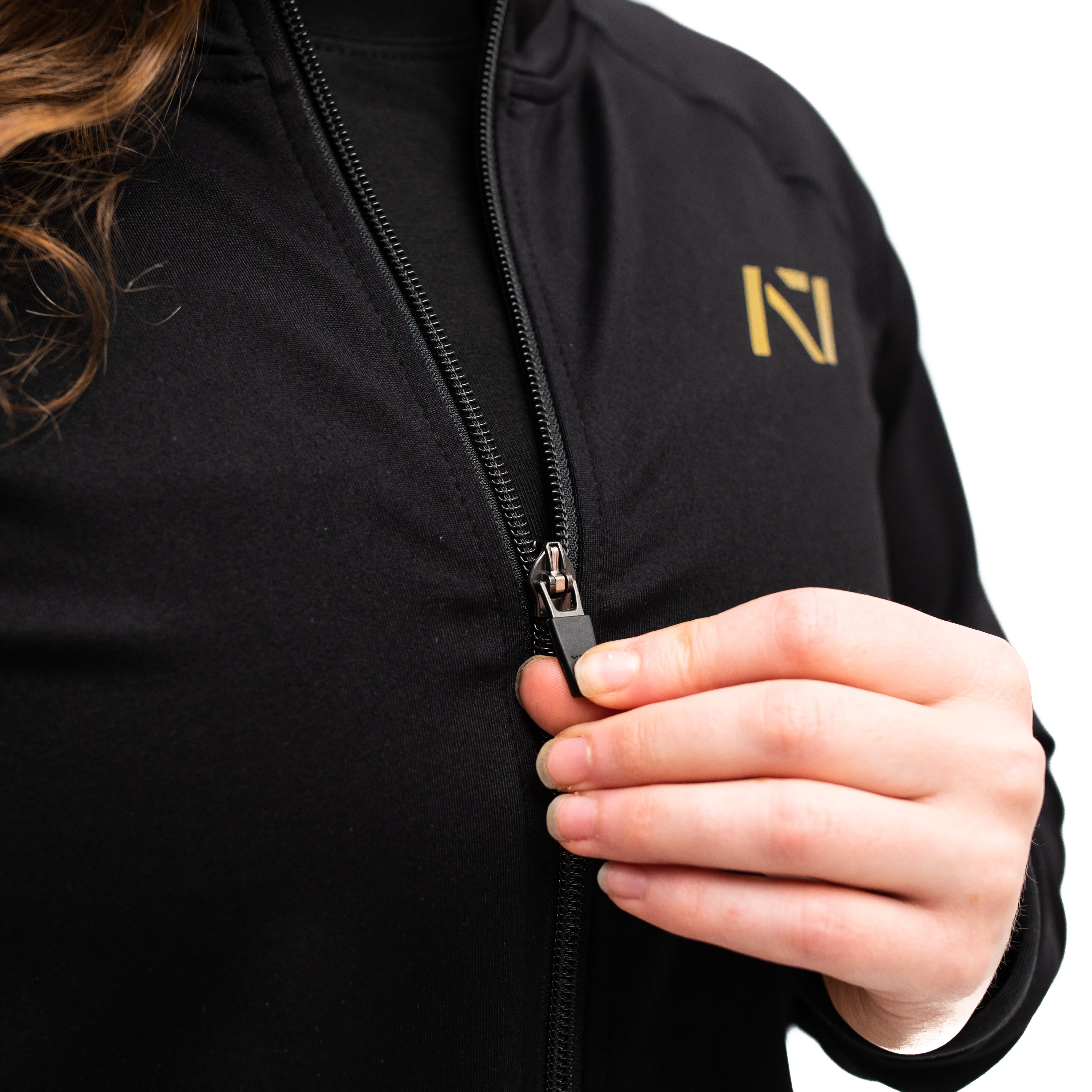 Close-up of YKK front zipper and hidden pocket zippers on the Gold Standard Defy Jacket.