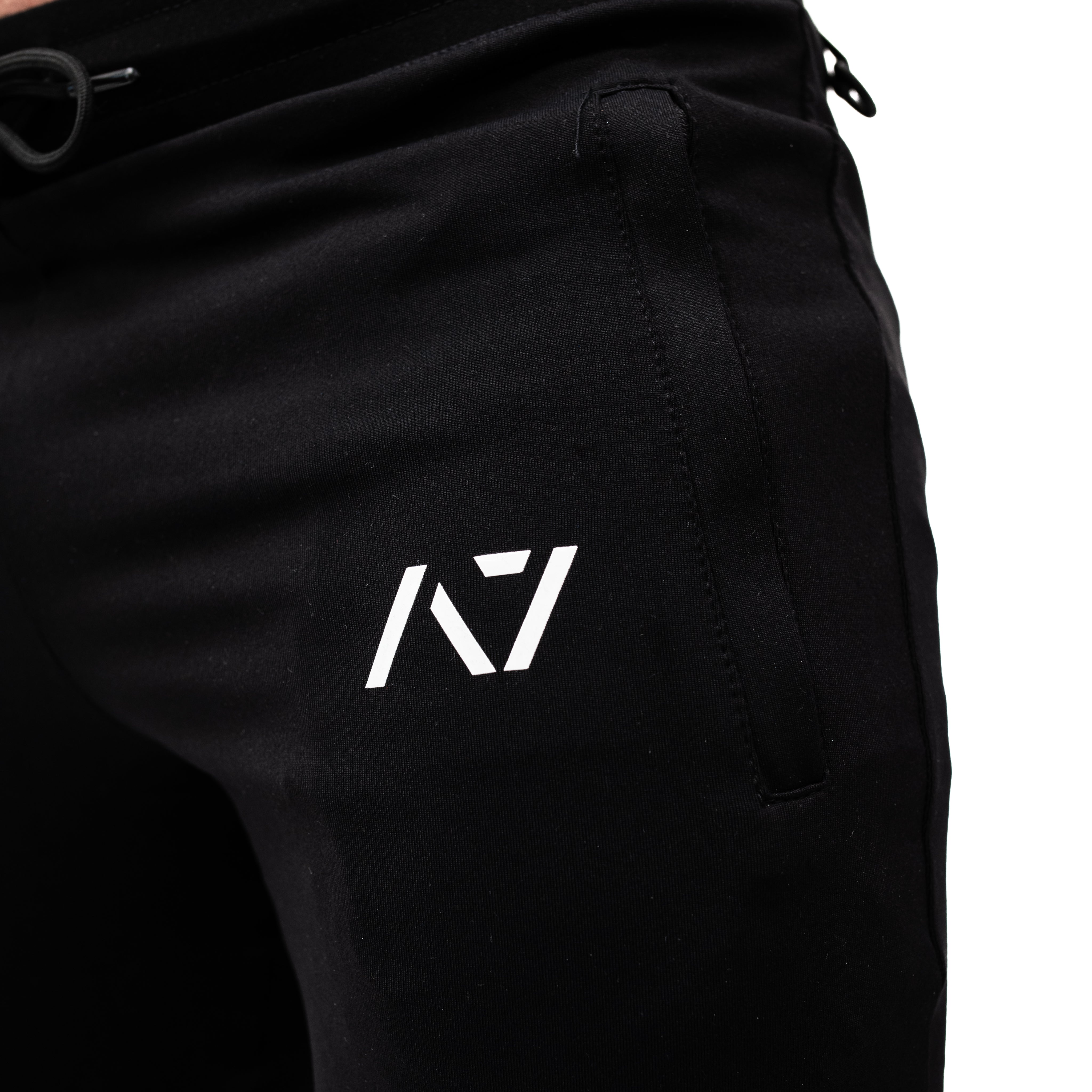 Close-up of silicone A7 logo printed on thigh of Defy Joggers – Black for subtle branding.