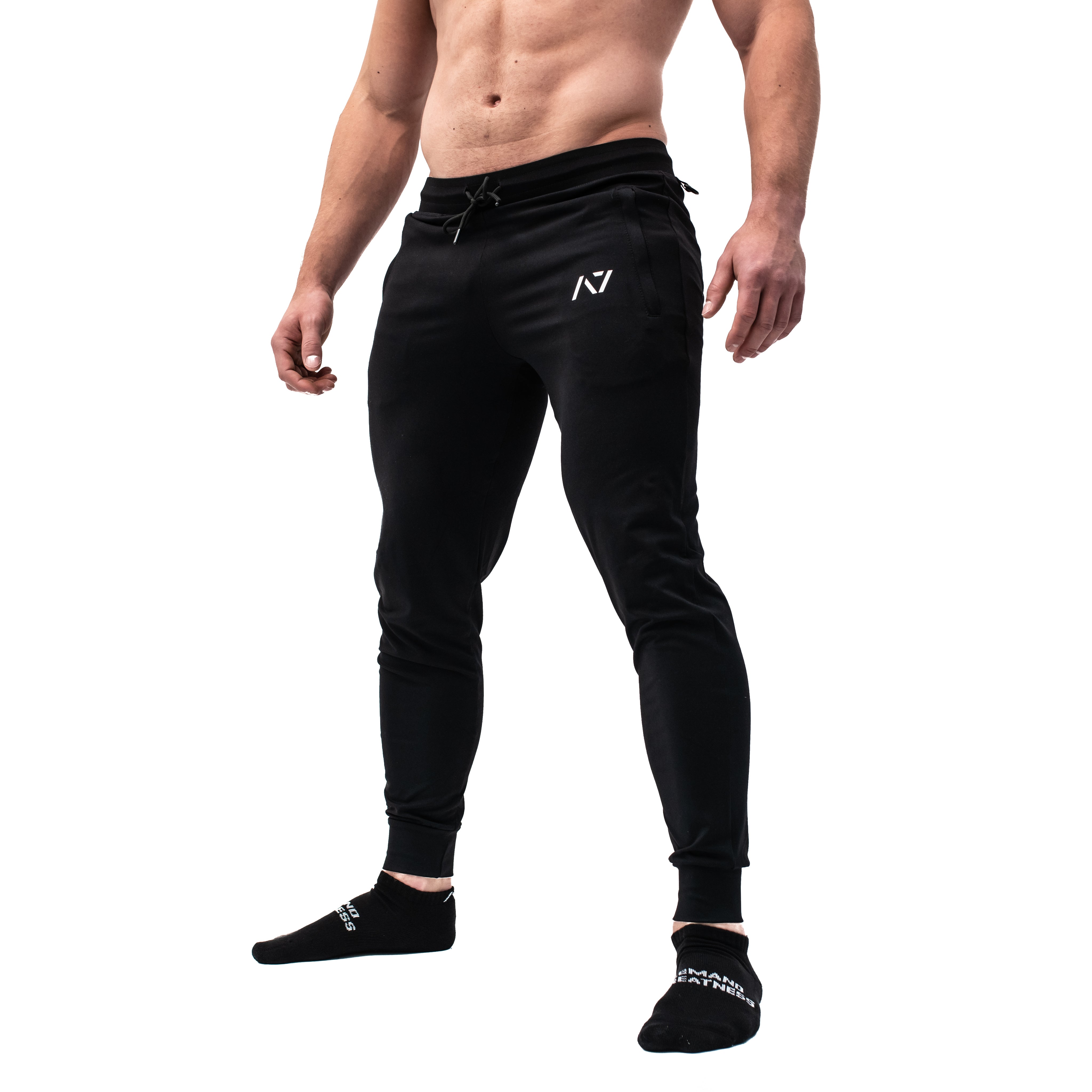 Side profile of A7 Defy Joggers – Black showing elastic cuff, key clip, and stretch fit.