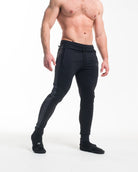 Man wearing black jogger pants on a white background