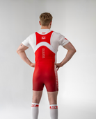 Person wearing a red and white powerlifting singlet with a visible brand logo on a light gray background