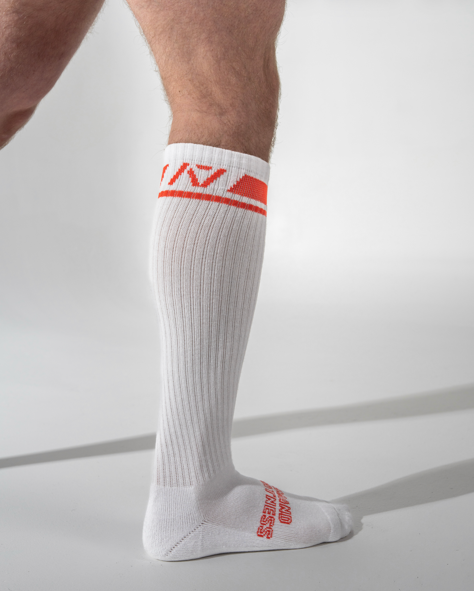 White knee-high sock with red logo and text on a light gray background