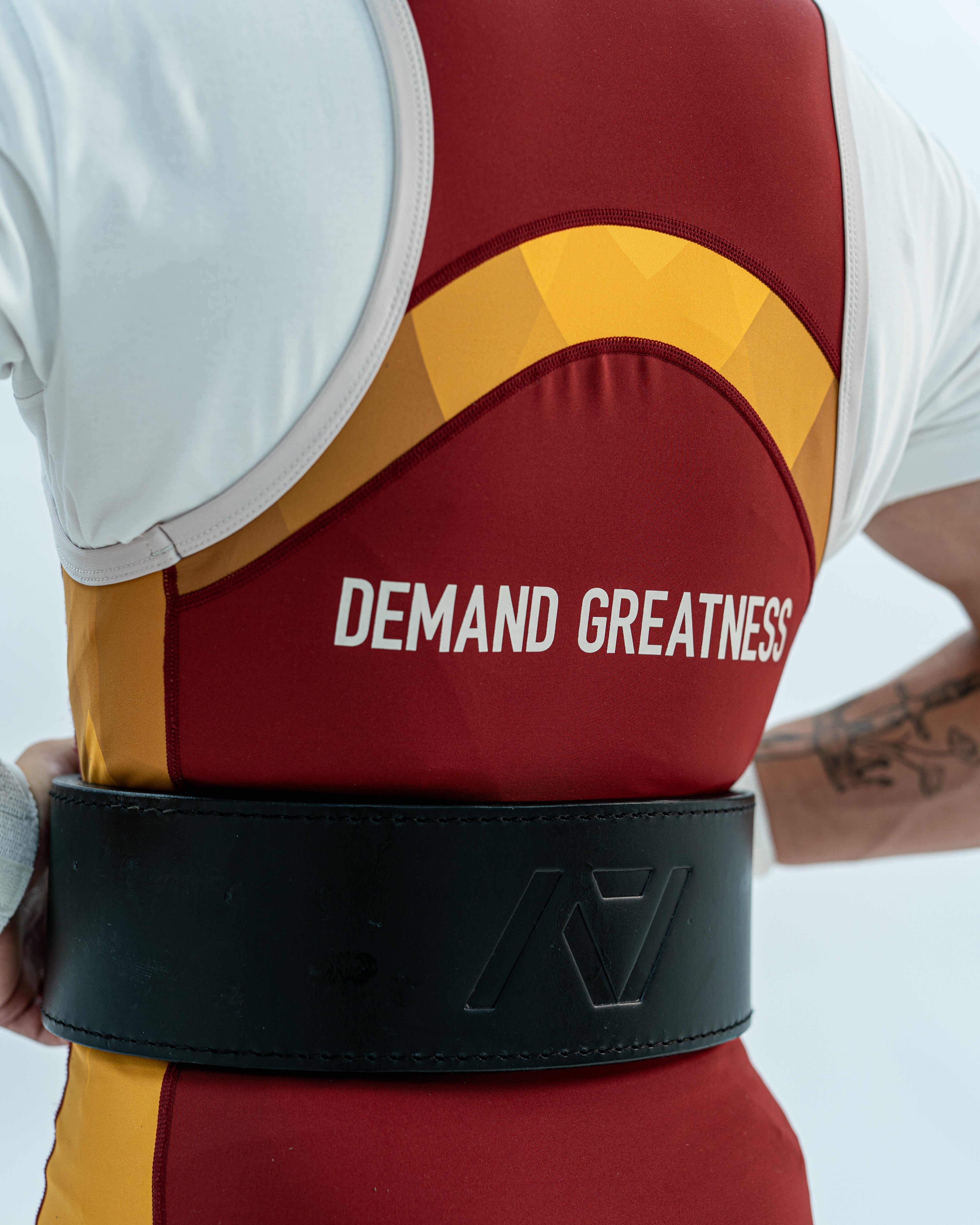 Close up of the back DEMAND GREATNESS lettering and cut of the rausch singlet